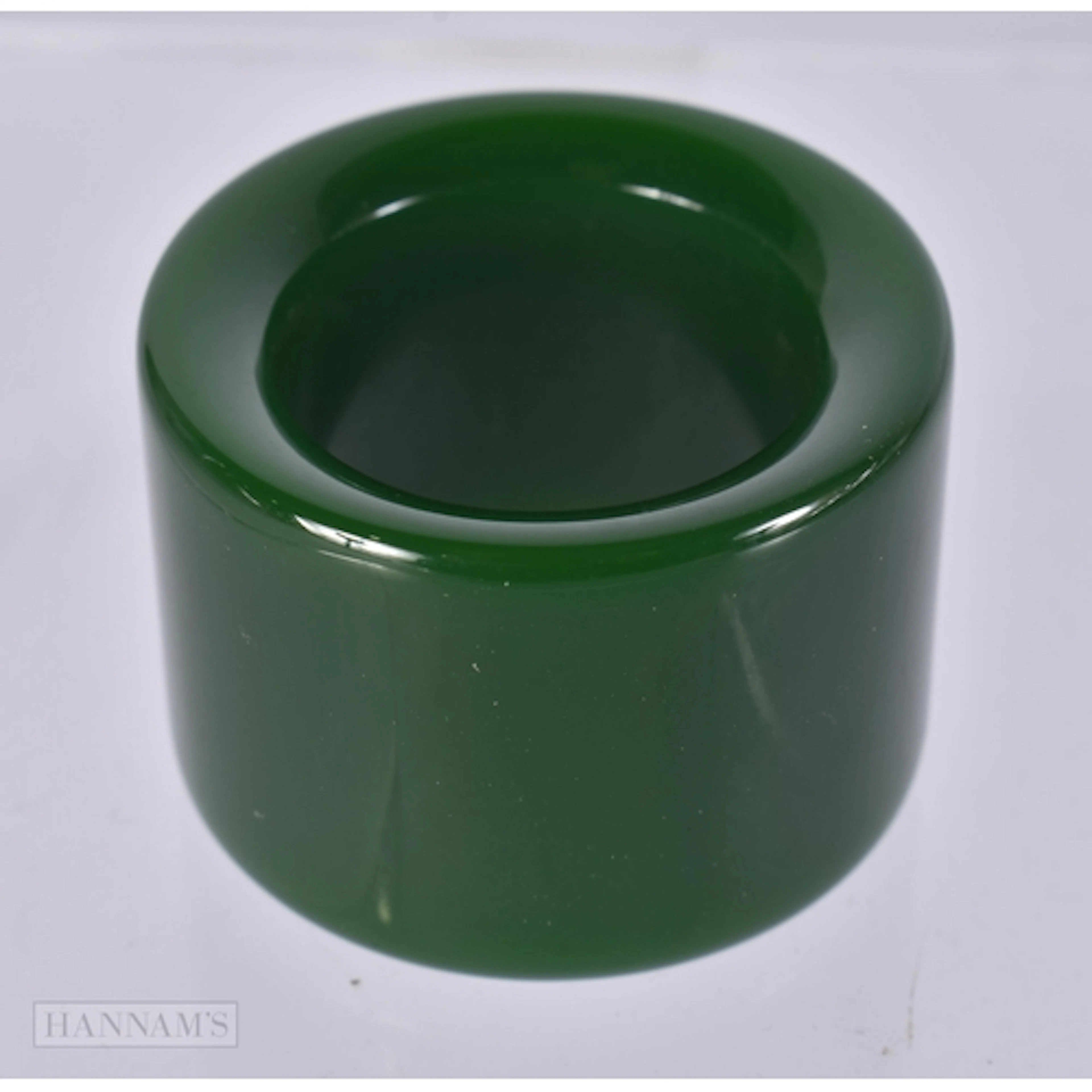 A SPINACH JADE ARCHERS RING. size z