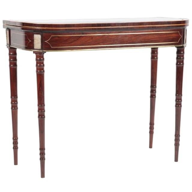 A Regency rosewood and brass inlaid card table, in the manne...