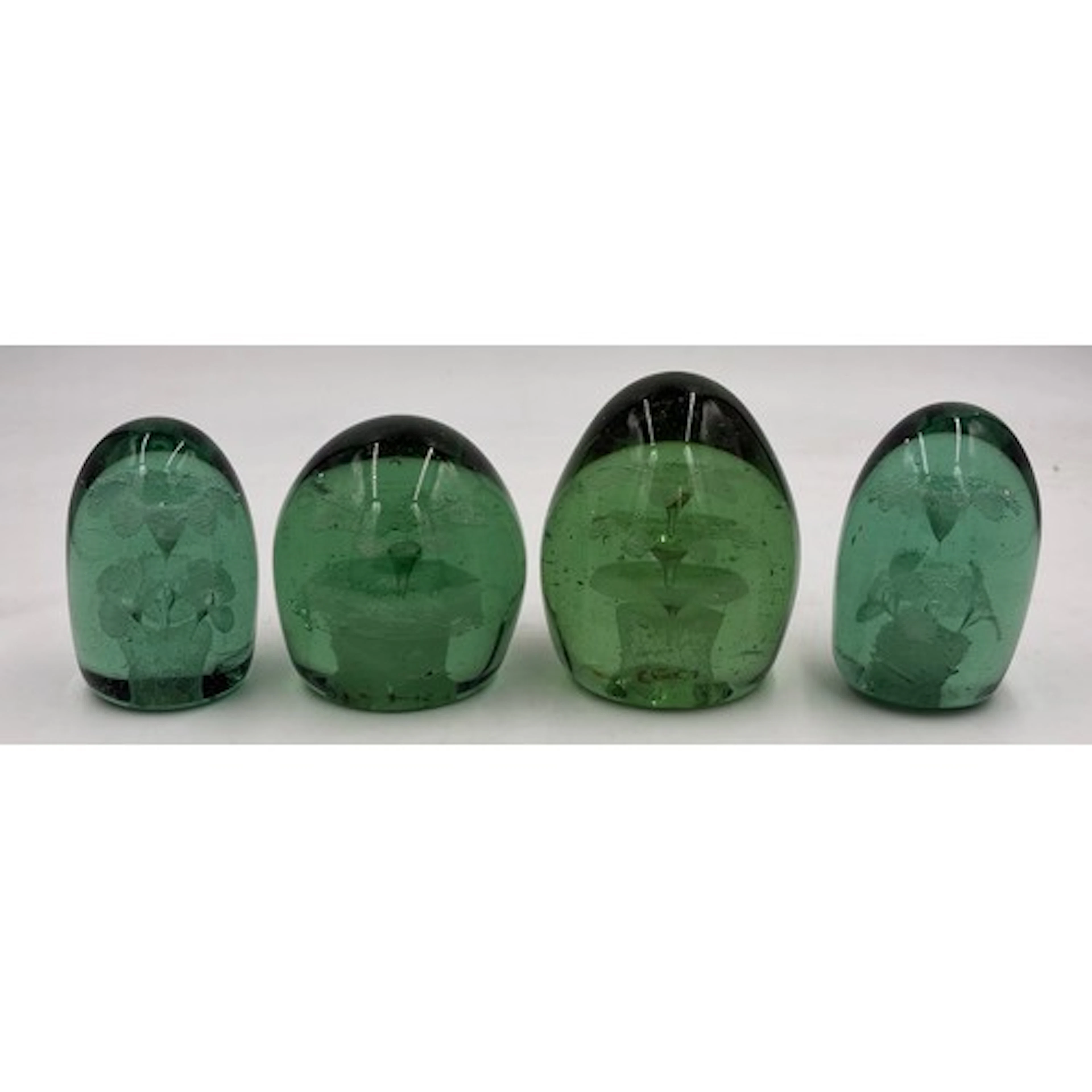 A collection of four Victorian green glass dump paperweights...
