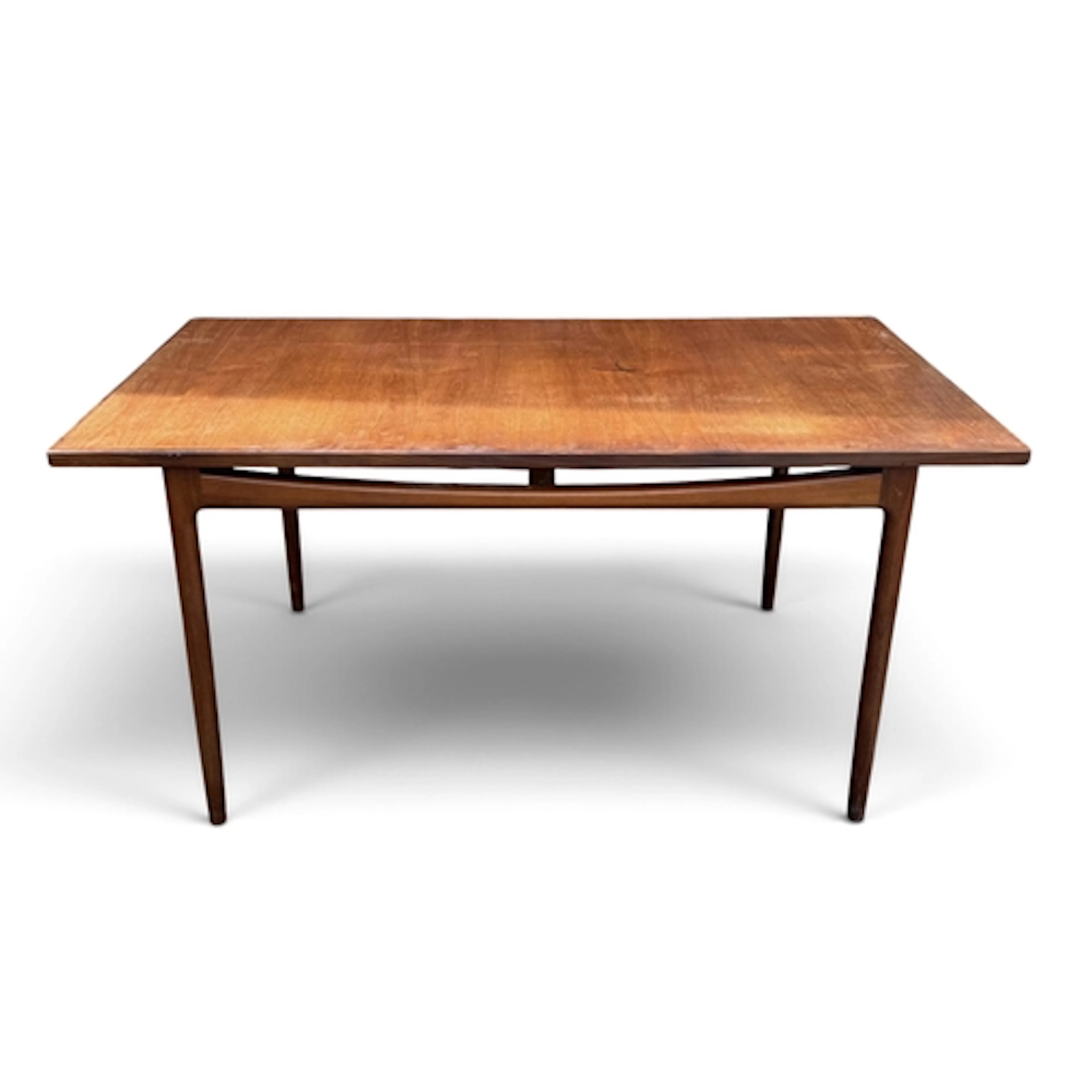 A MID-CENTURY G PLAN TEAK EXTENDING DINING TABLE Designed by...