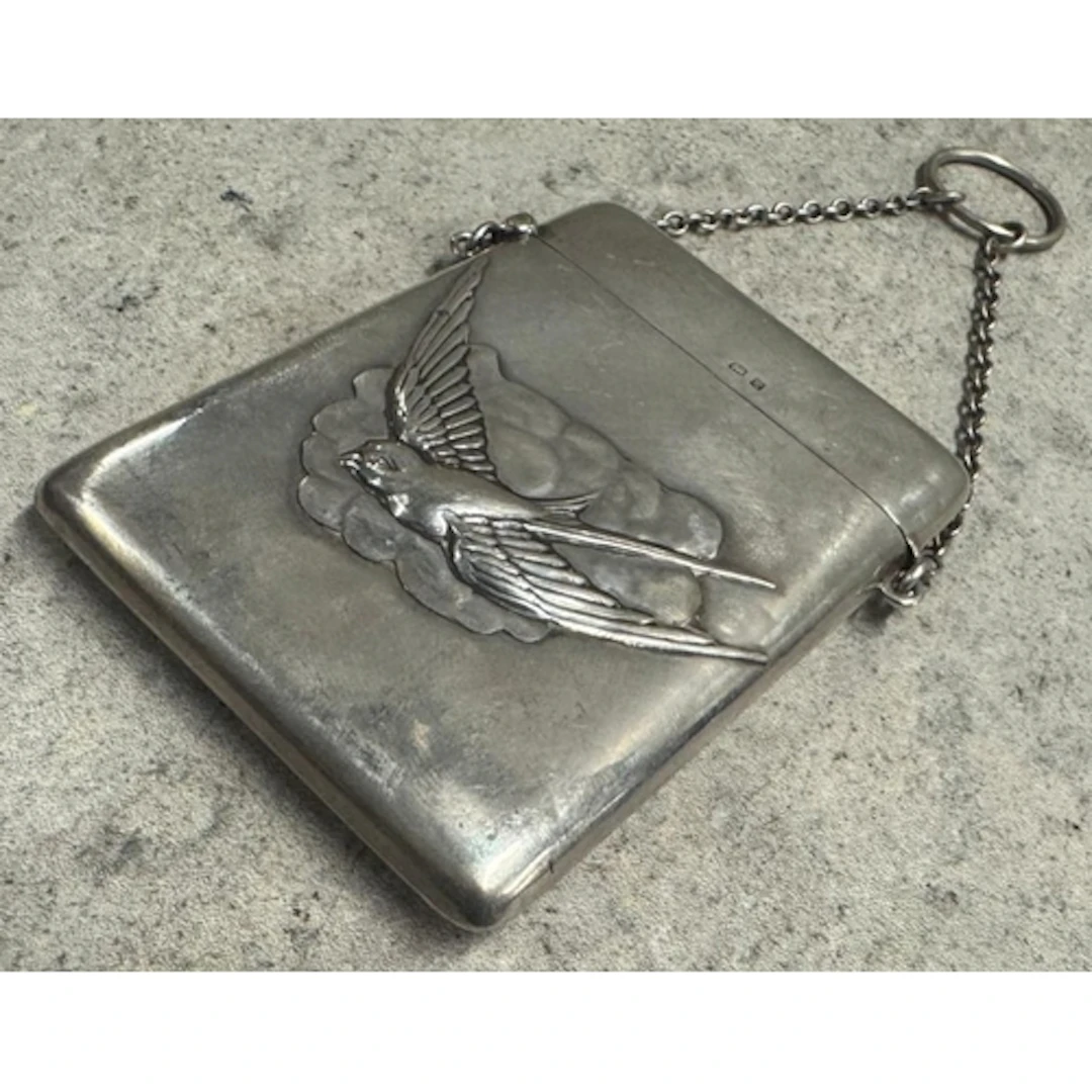 A novelty silver card case chased with bird decoration to ce...