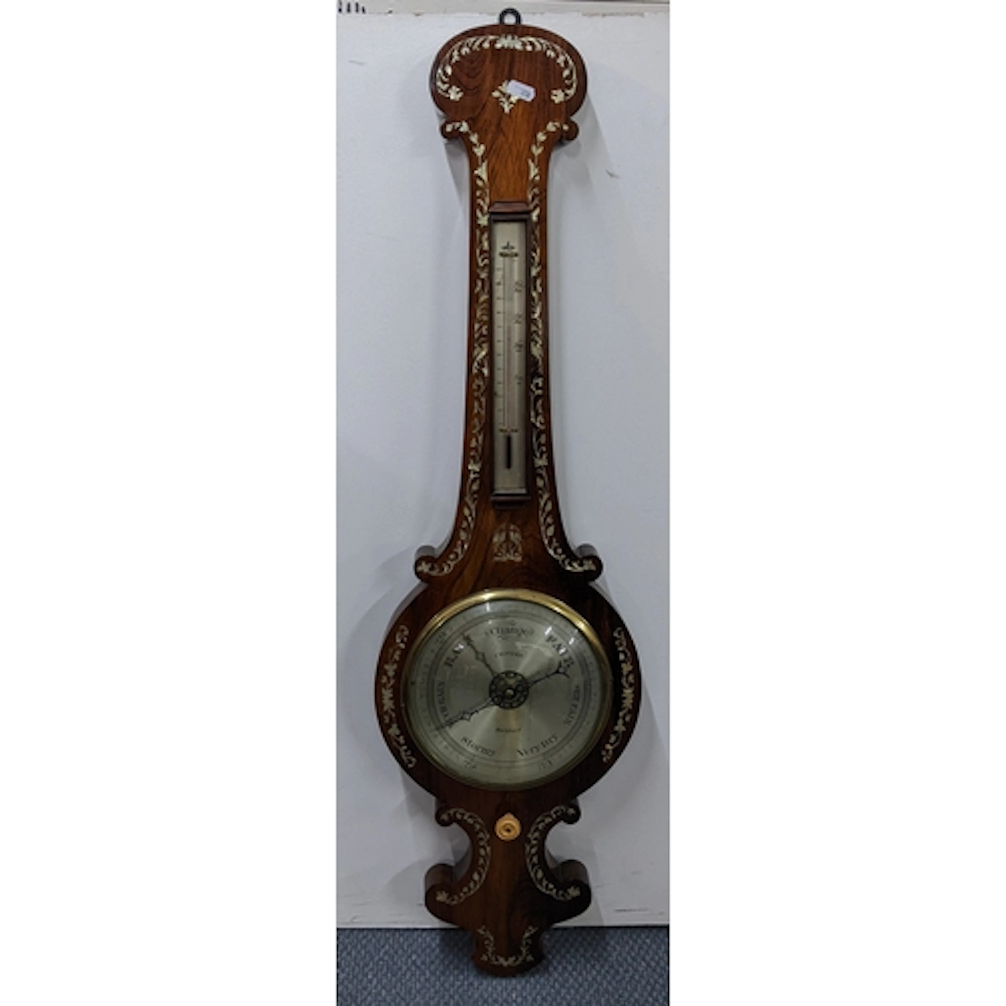 A William IV rosewood barometer having mother of pearl inlay...