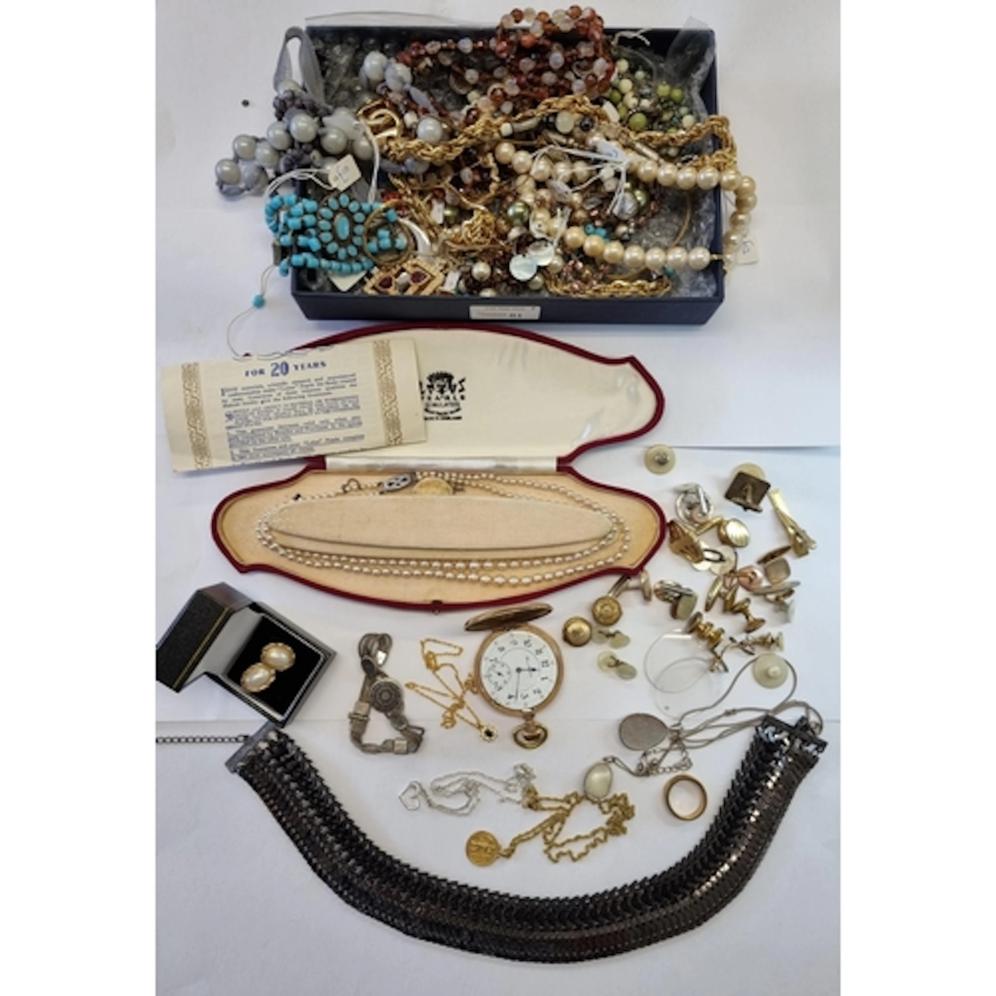 A strong box containing Costume Jewellery and other items in...