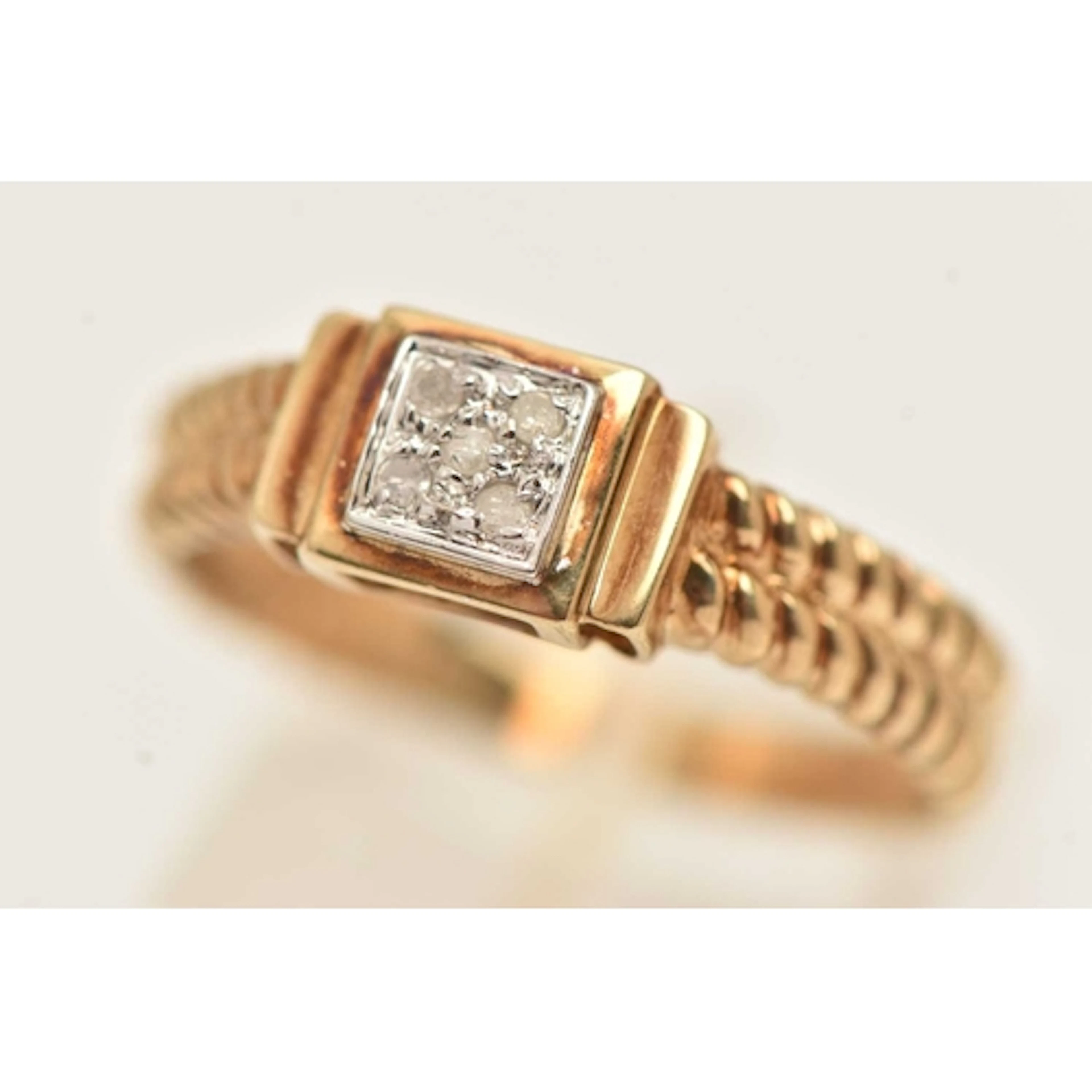 A 9CT GOLD GEM SET RING, a cluster of five single cut diamon...