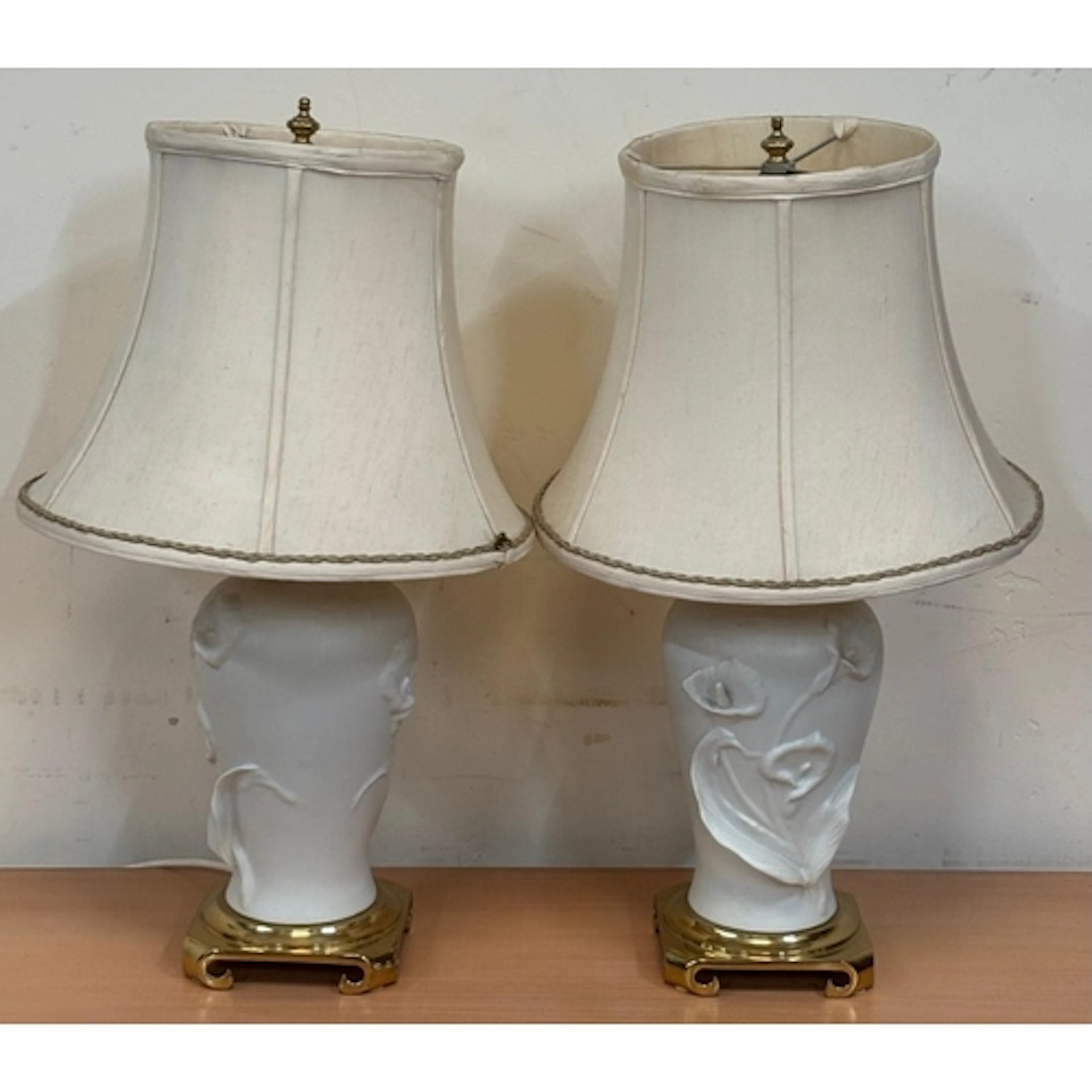 A pair of white lamps in the style of Calla Lily lamp in bis...