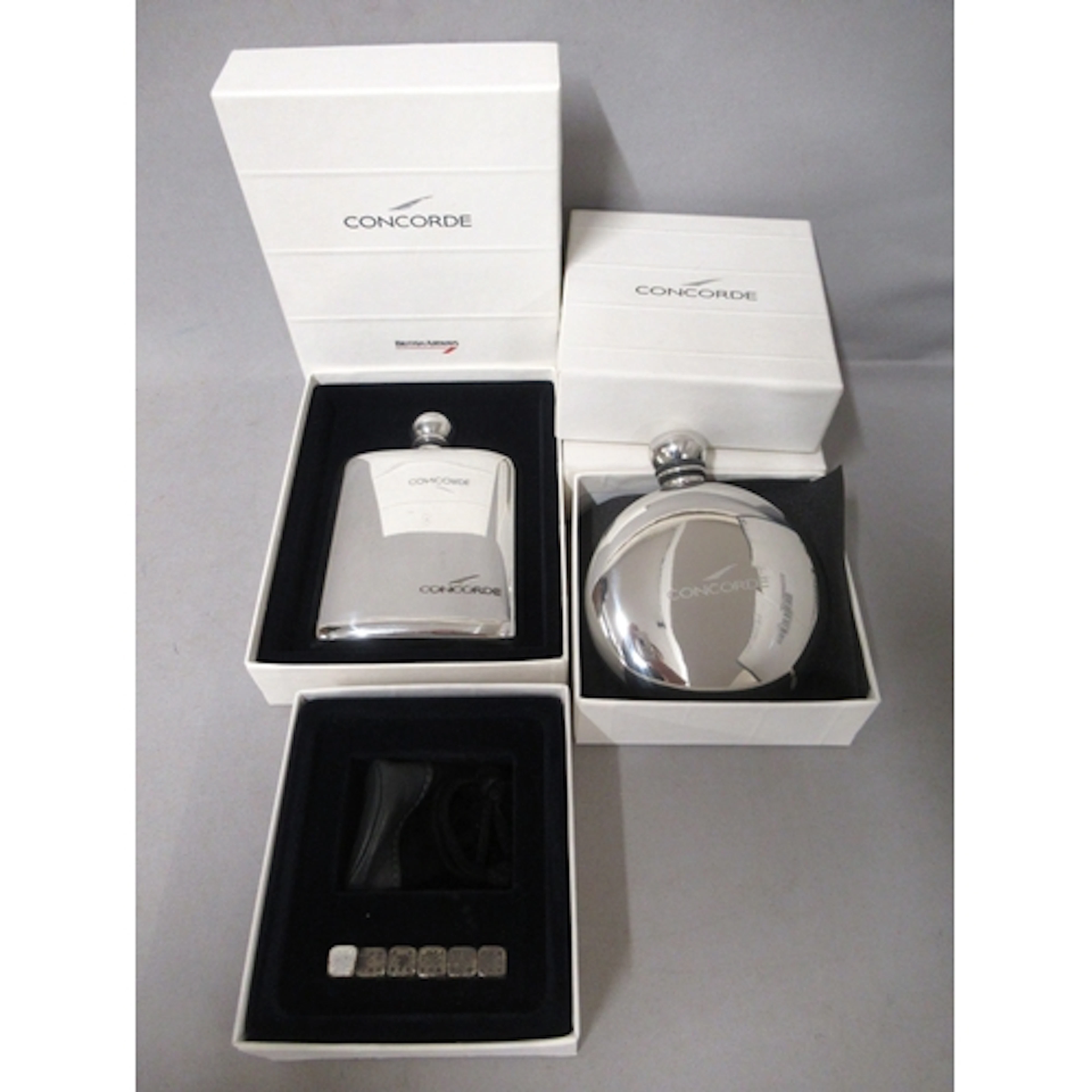 Two Concorde souvenir hip flasks in original packaging, toge...