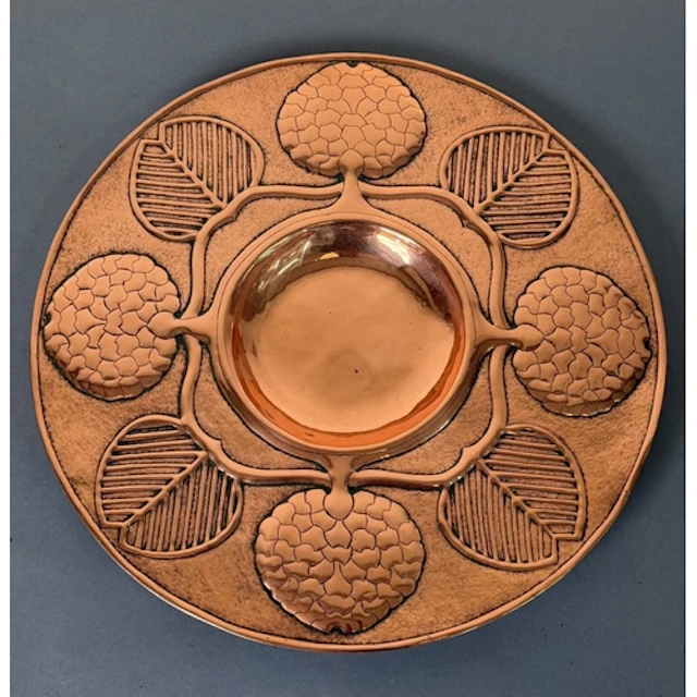 An Arts and Craft style Copper charger with central recessed...