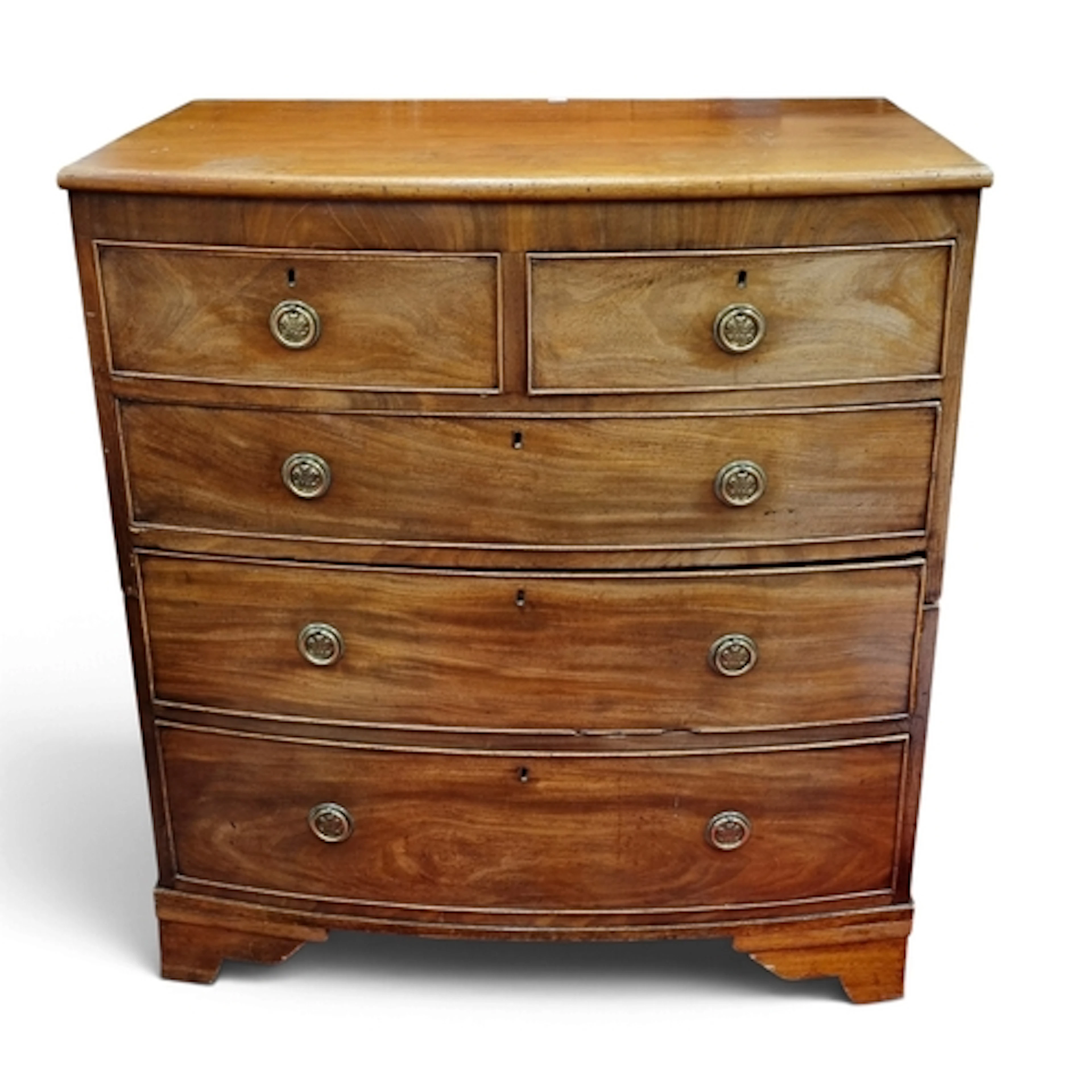 A Georgian Mahogany bow fronted Chest of Drawers, two short ...