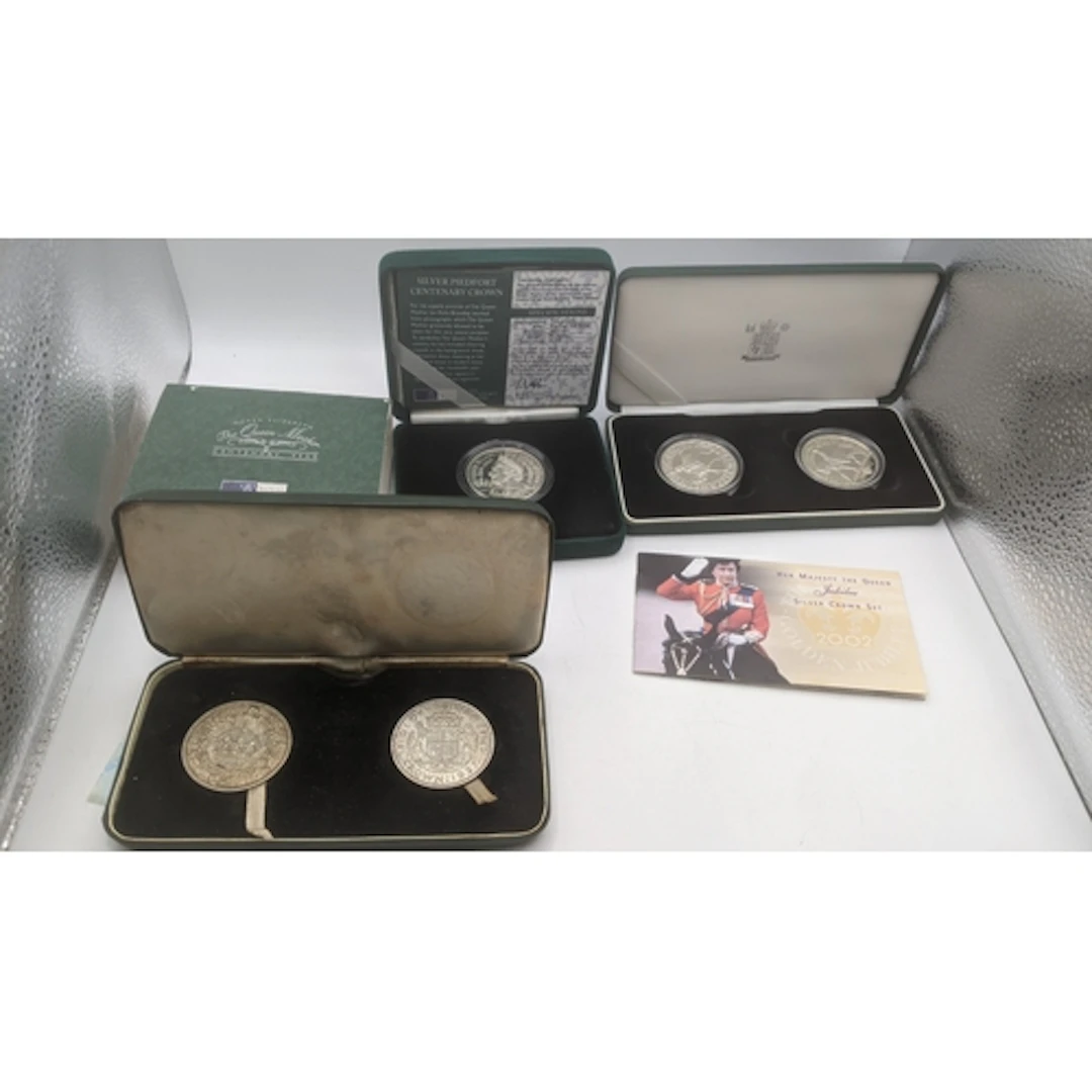 Three boxed commemorative coin sets to include a Queen Mothe...