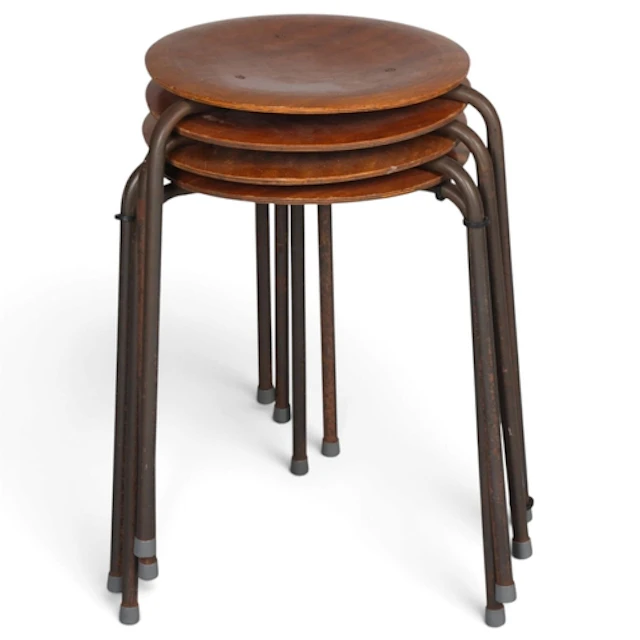 A set of 4 mid-century stacking stools, with plywood seats o...