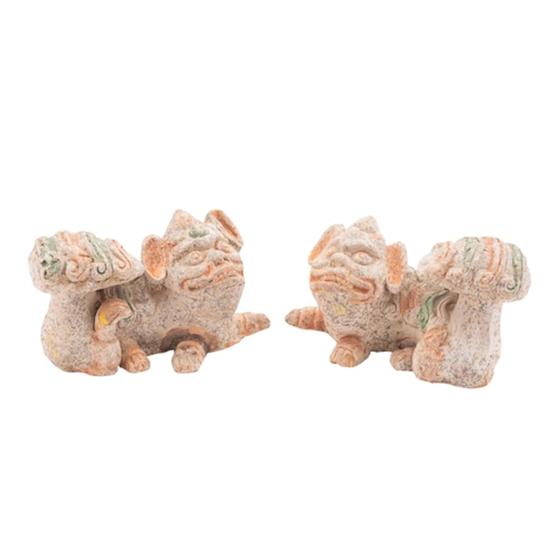 A pair of Chinese terracotta Fu dogs in Tang style with poly...