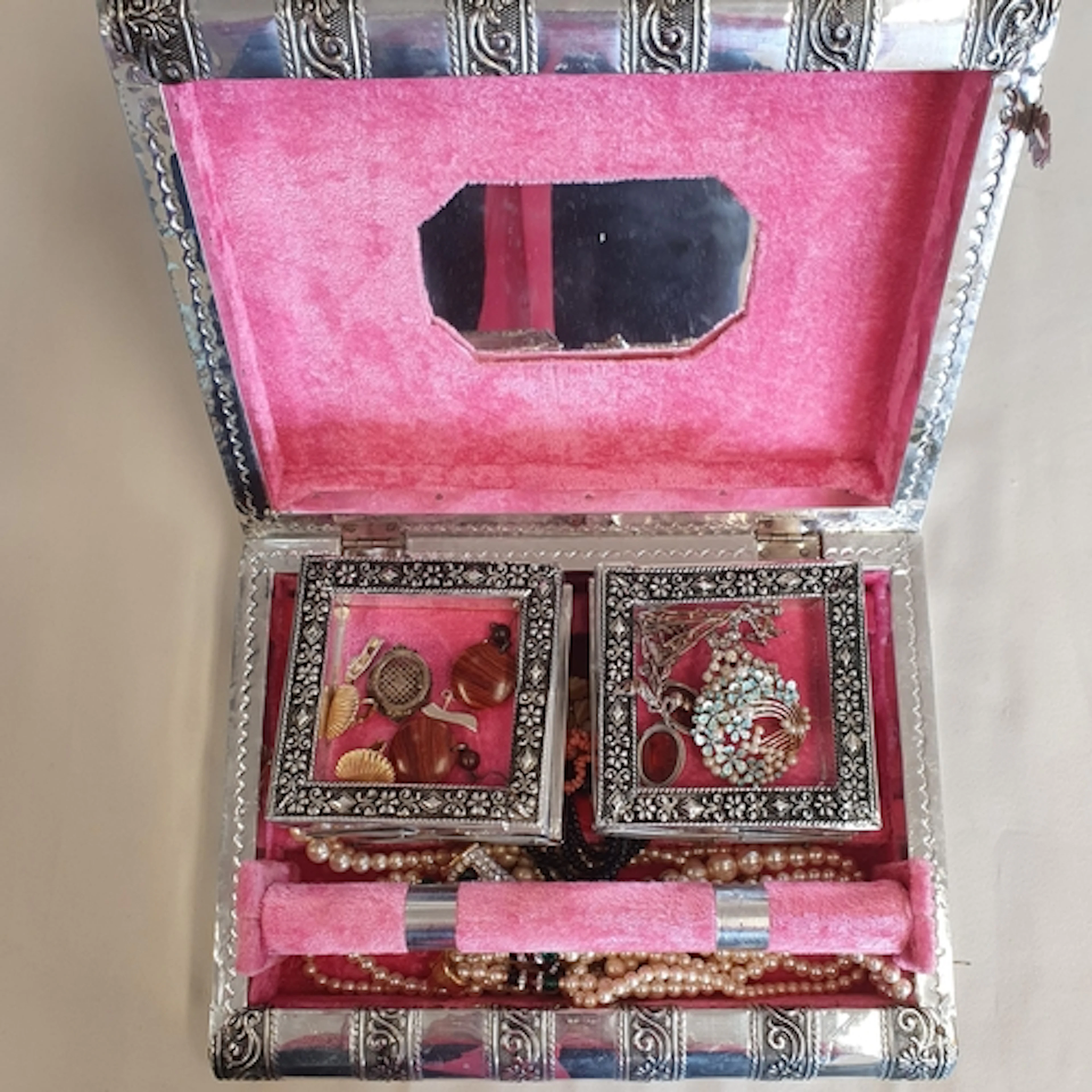 A white metal Jewel Box formed as a book containing faux pea...