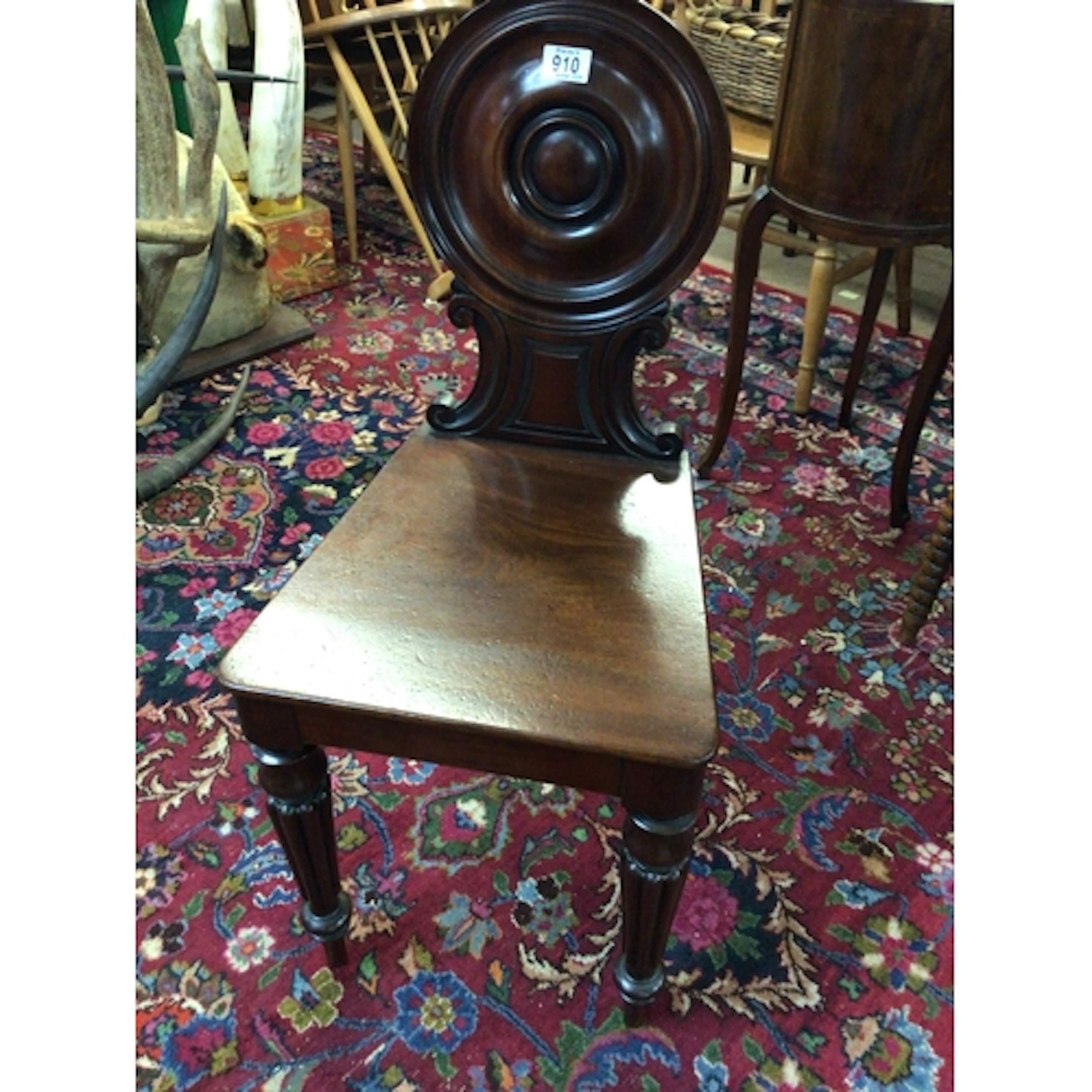 A Quality late Regency Mahogany hall chair with a shaped bac...