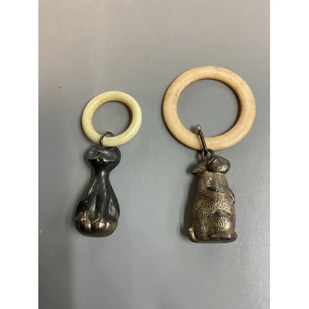 Two vintage teething rings, one of a rabbit the other of a s...