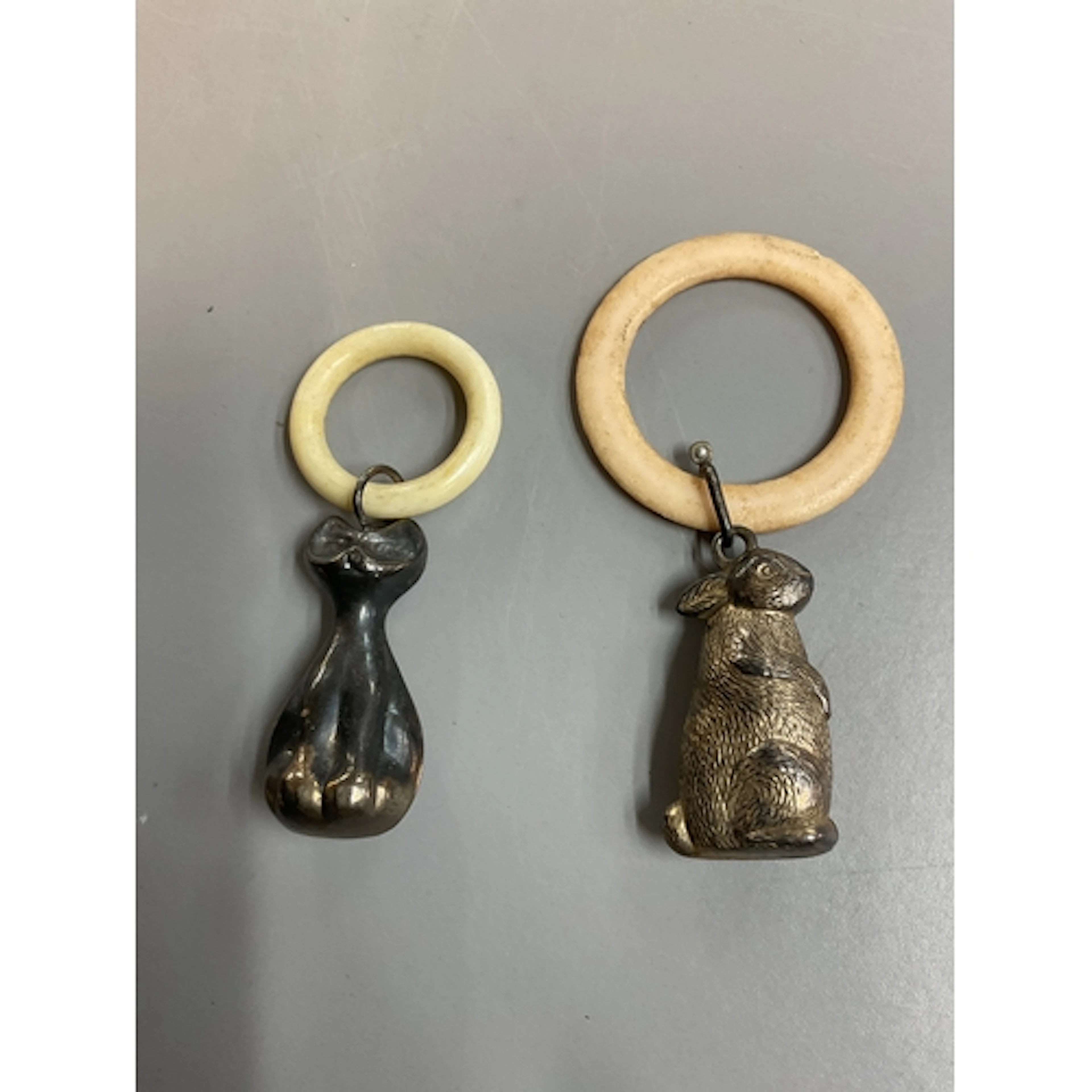 Two vintage teething rings, one of a rabbit the other of a s...