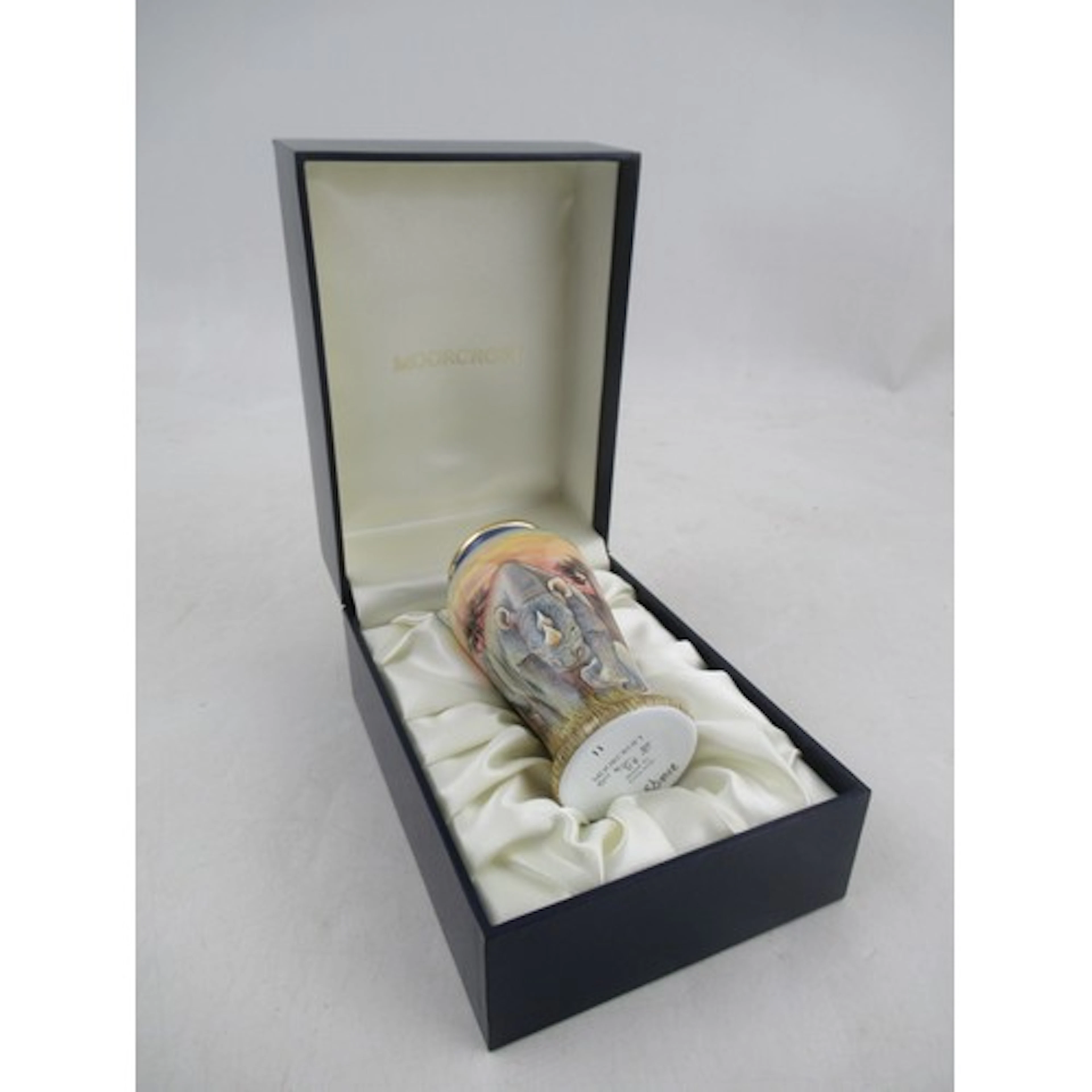 A boxed Moorcroft enamel vase, decorated with Rhinos by Sand...