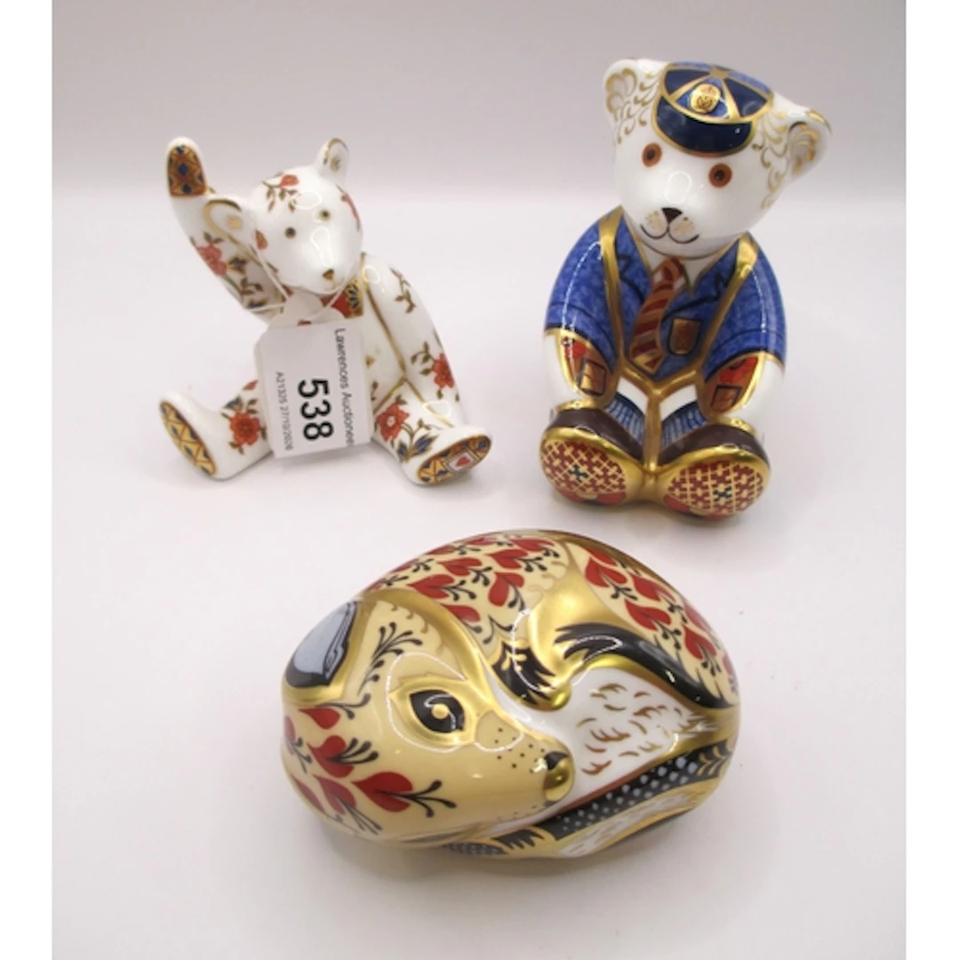 Two Royal Crown Derby paperweights, and a similar figure of ...