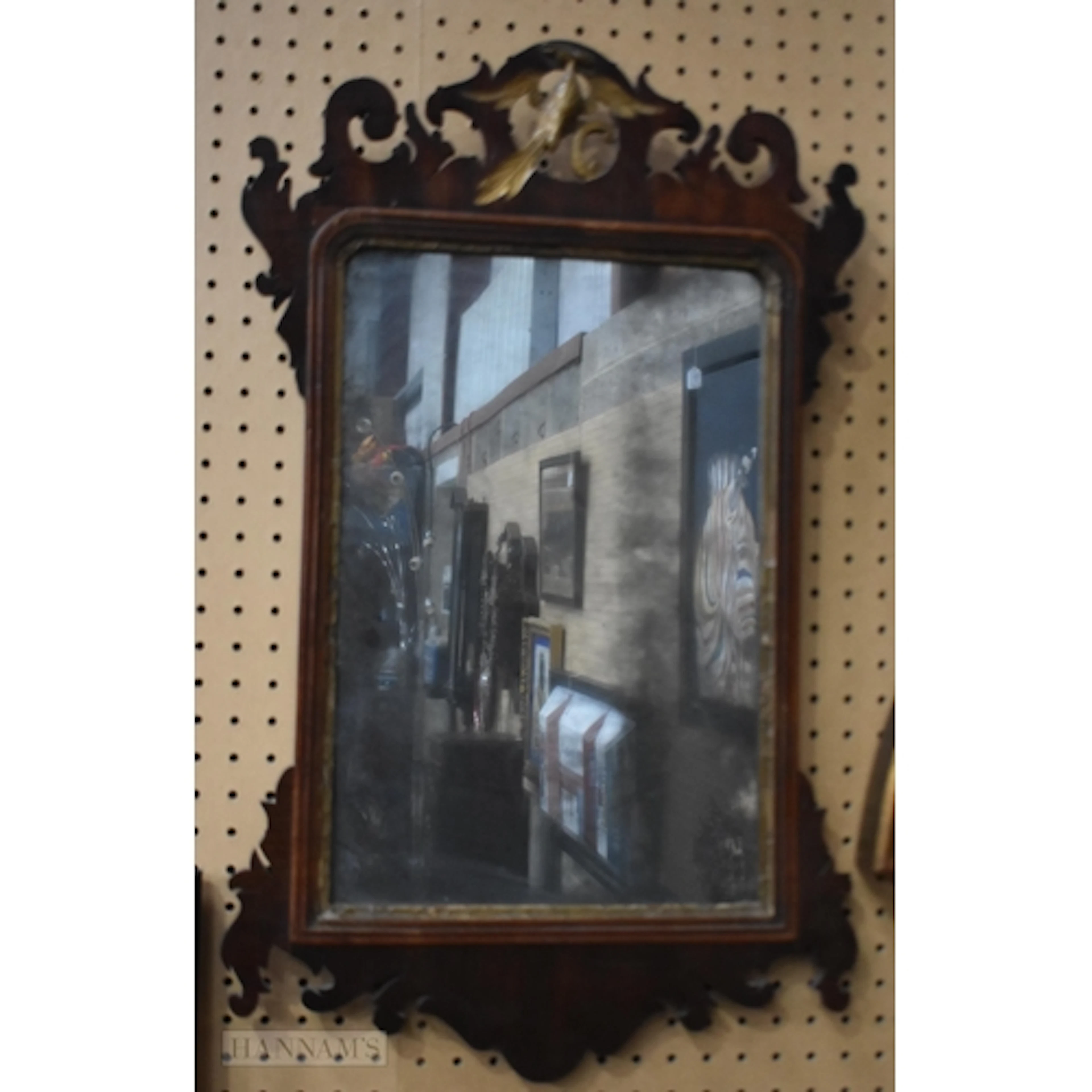 A Georgian fretwork mirror with a carved giltwood phoenix bi...