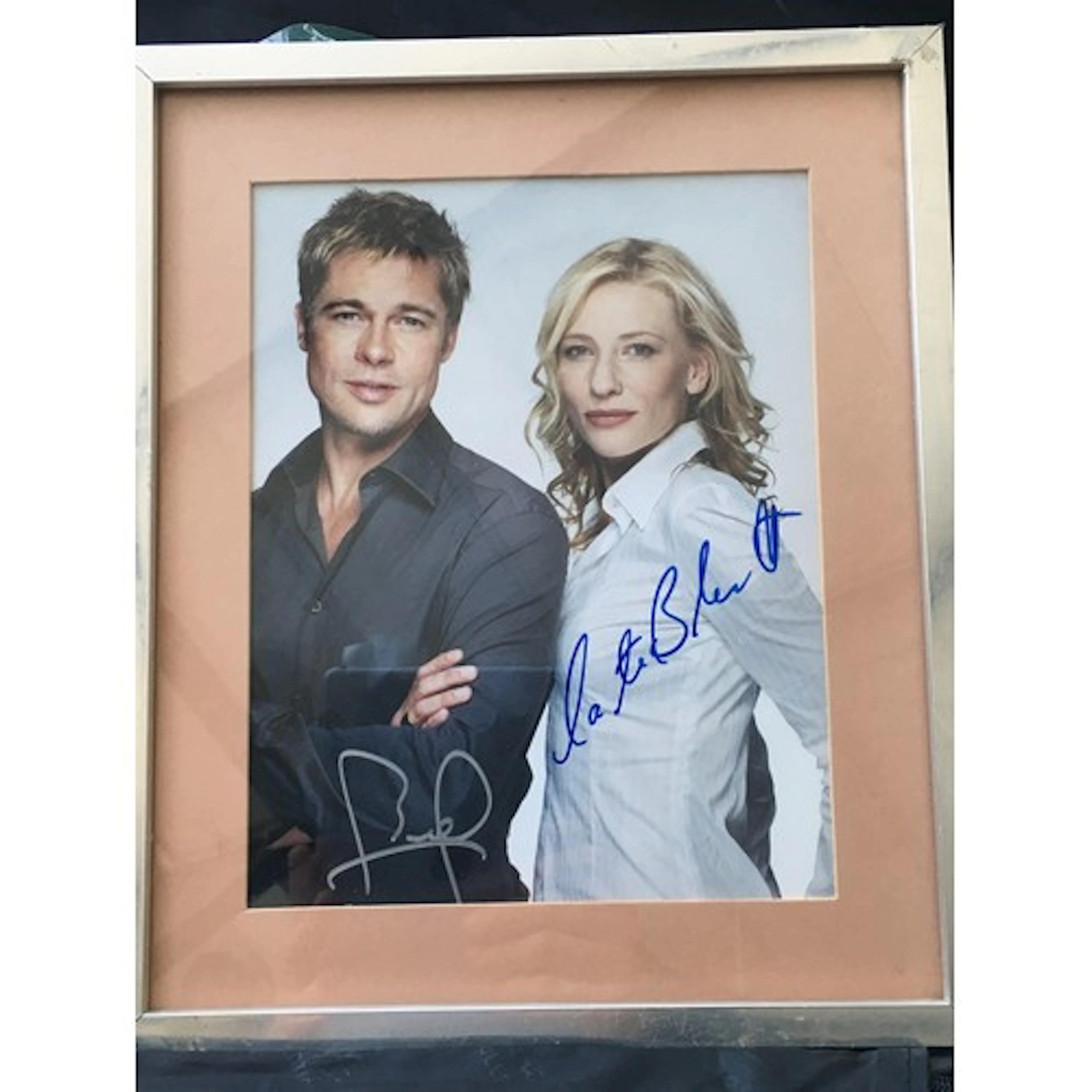 A framed and glazed siged photo of Brad Pitt and Cate Blanch...