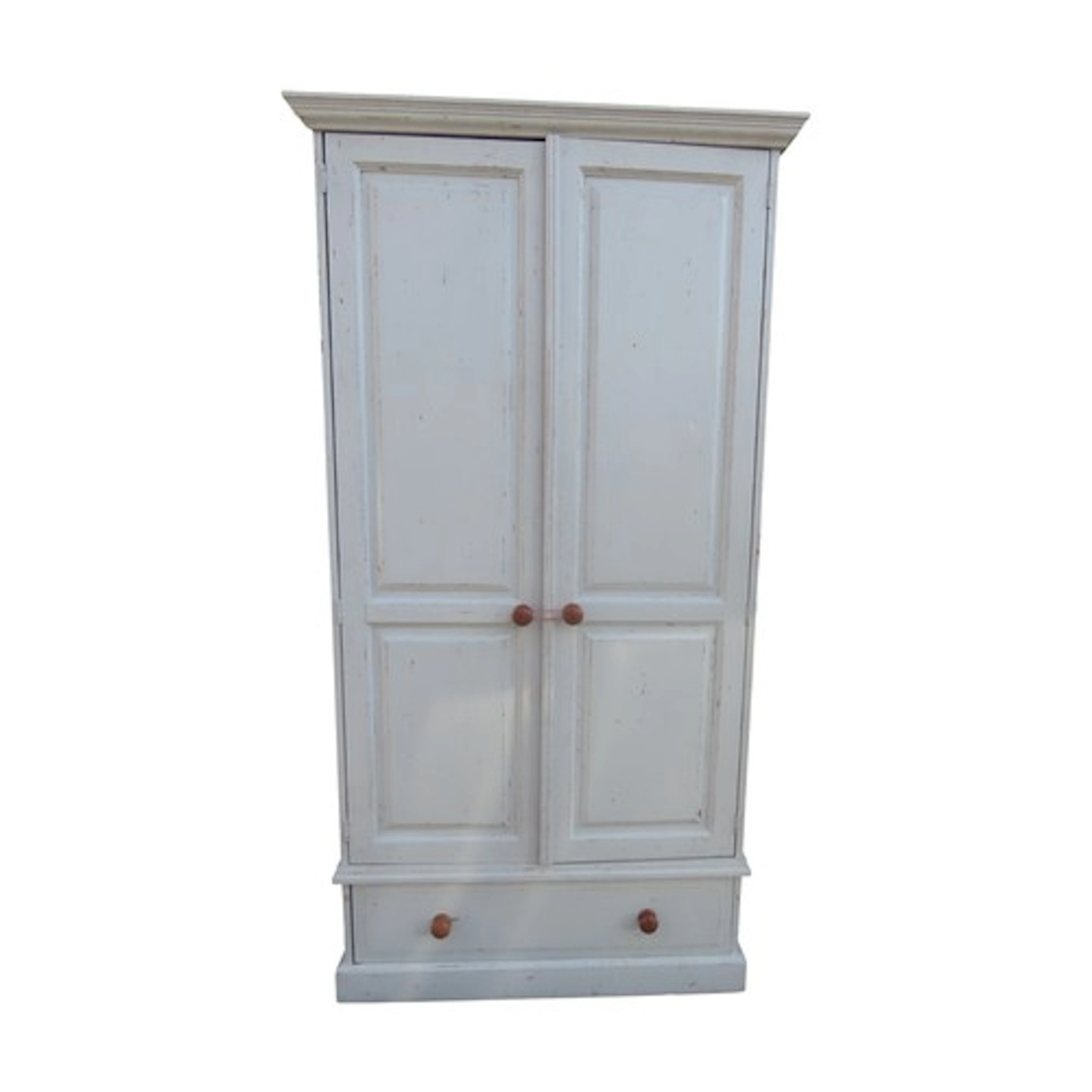 A painted an distressed pine wardrobe enclosed by a pair of ...