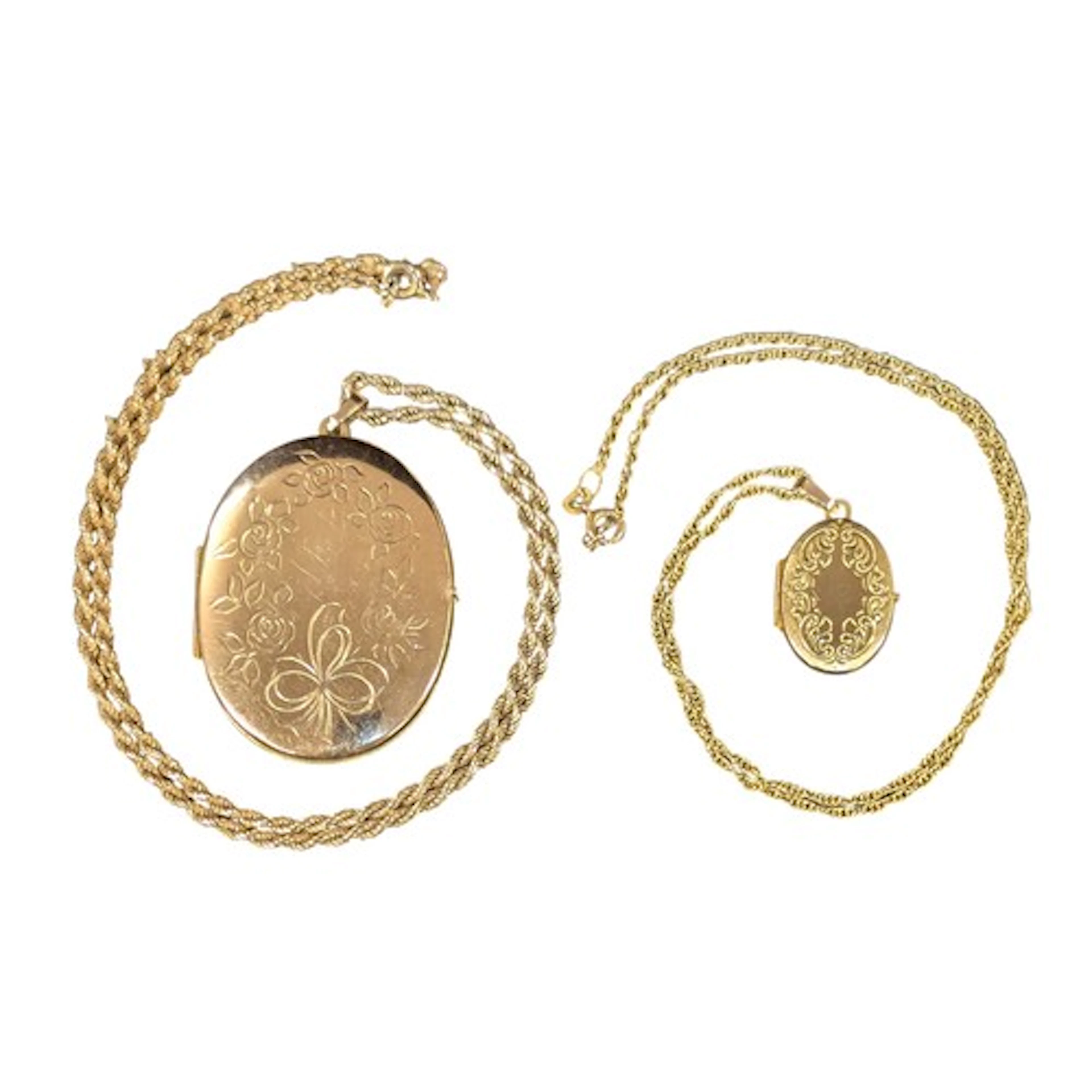 A large oval 9ct gold locket pendant with 9ct rope twist nec...