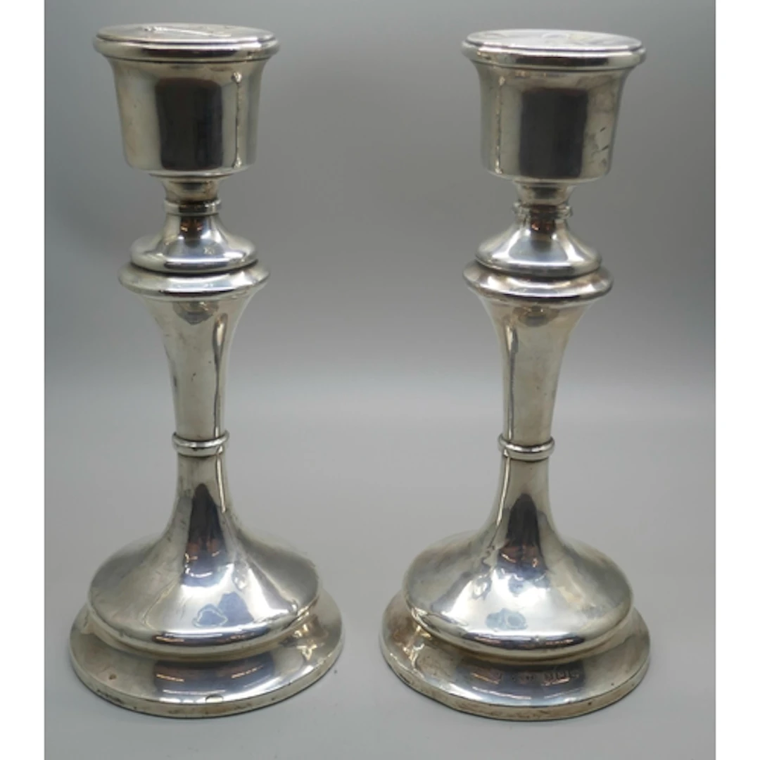 A pair of George V silver candlesticks with weighted bases, ...