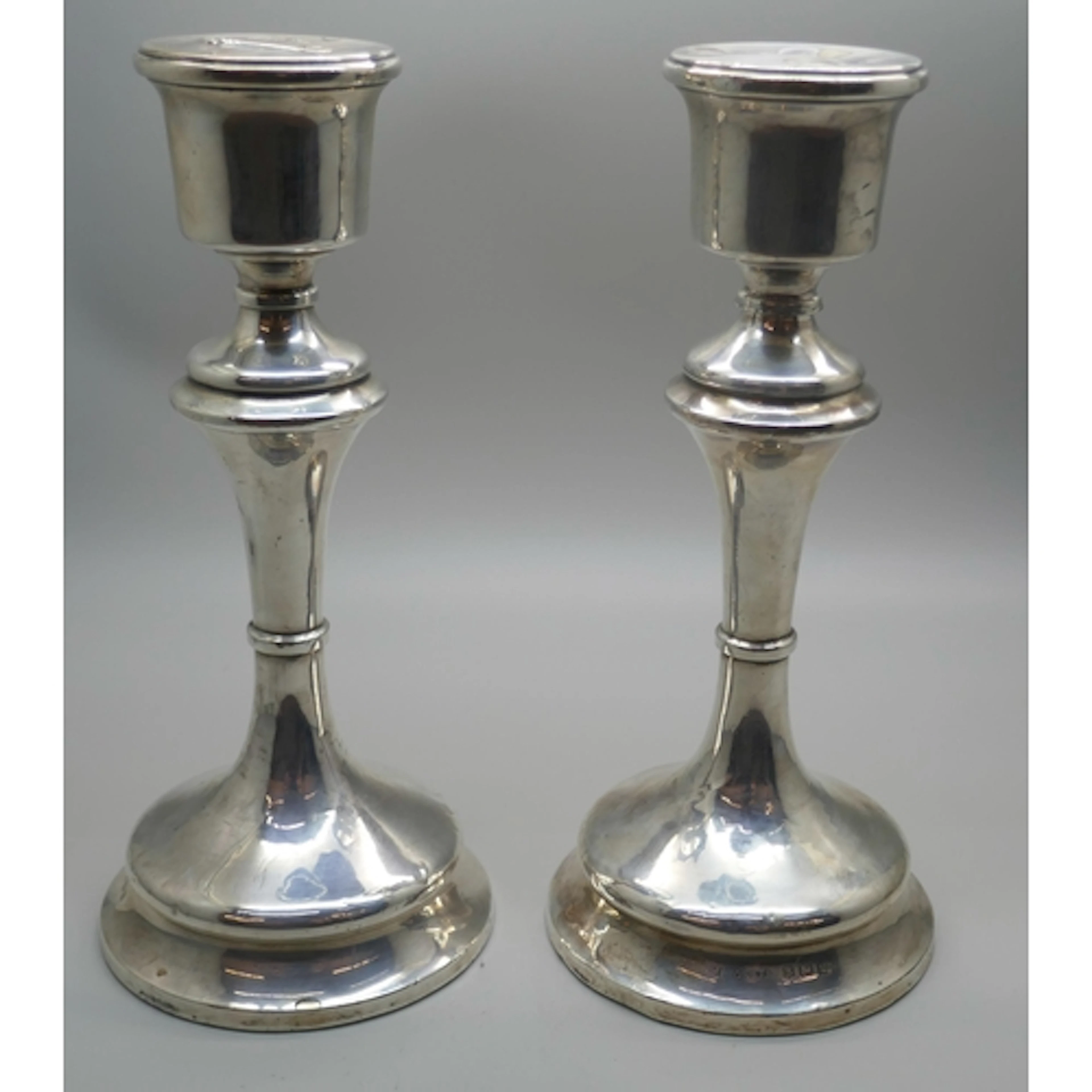 A pair of George V silver candlesticks with weighted bases, ...