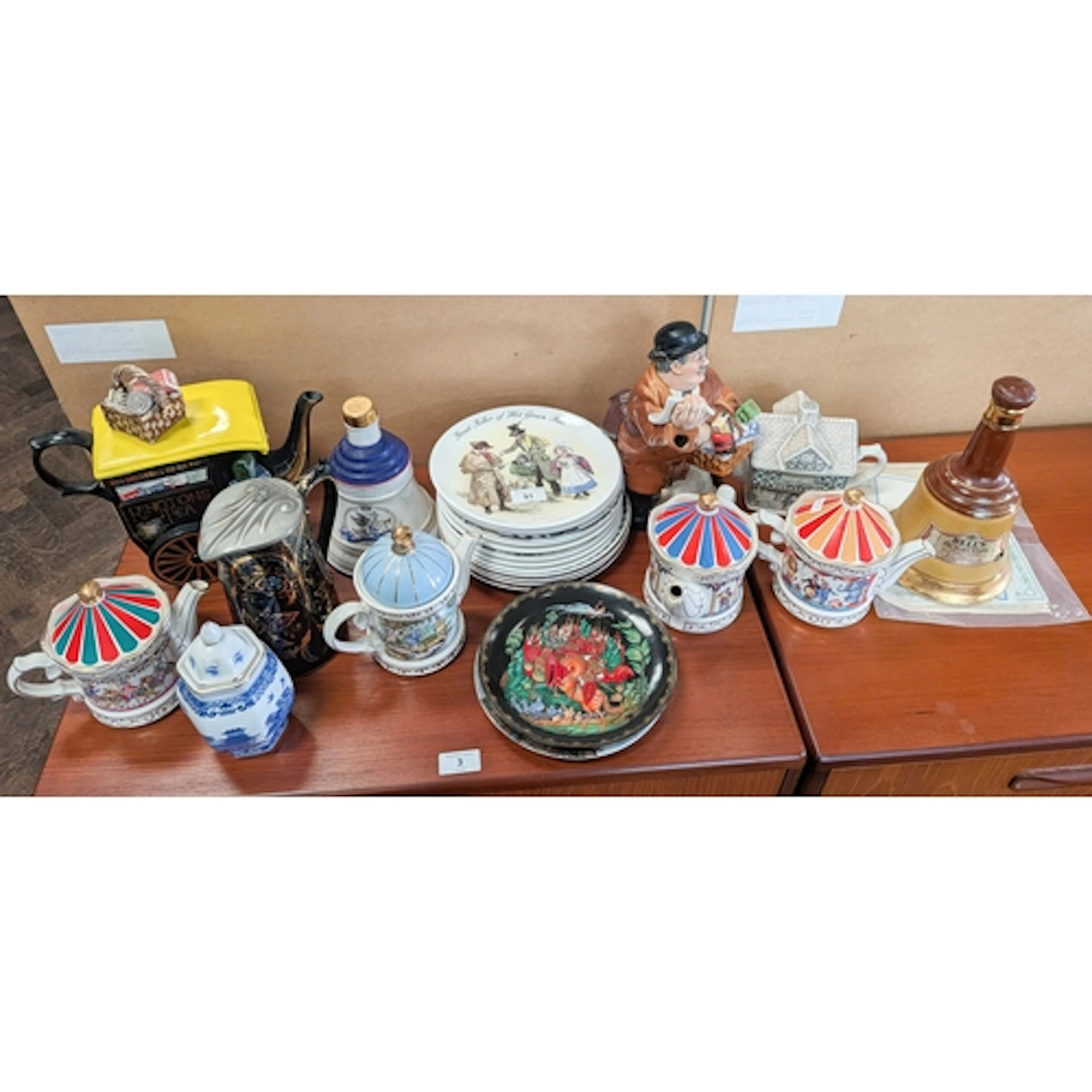 Various novelty teapots, decorative plates, two Bells whiske...