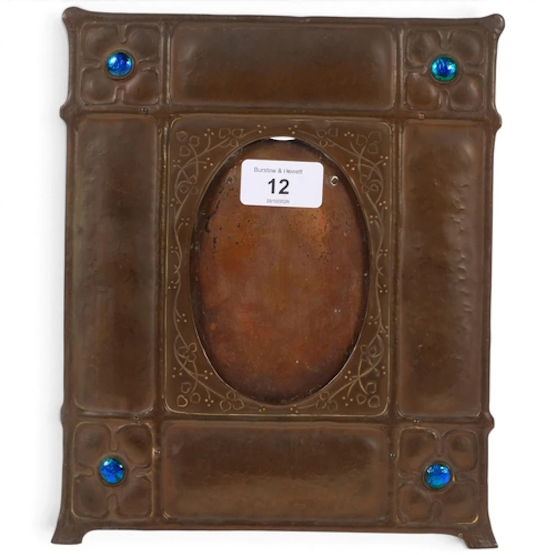 An Arts and Crafts Period embossed copper photo frame, with ...