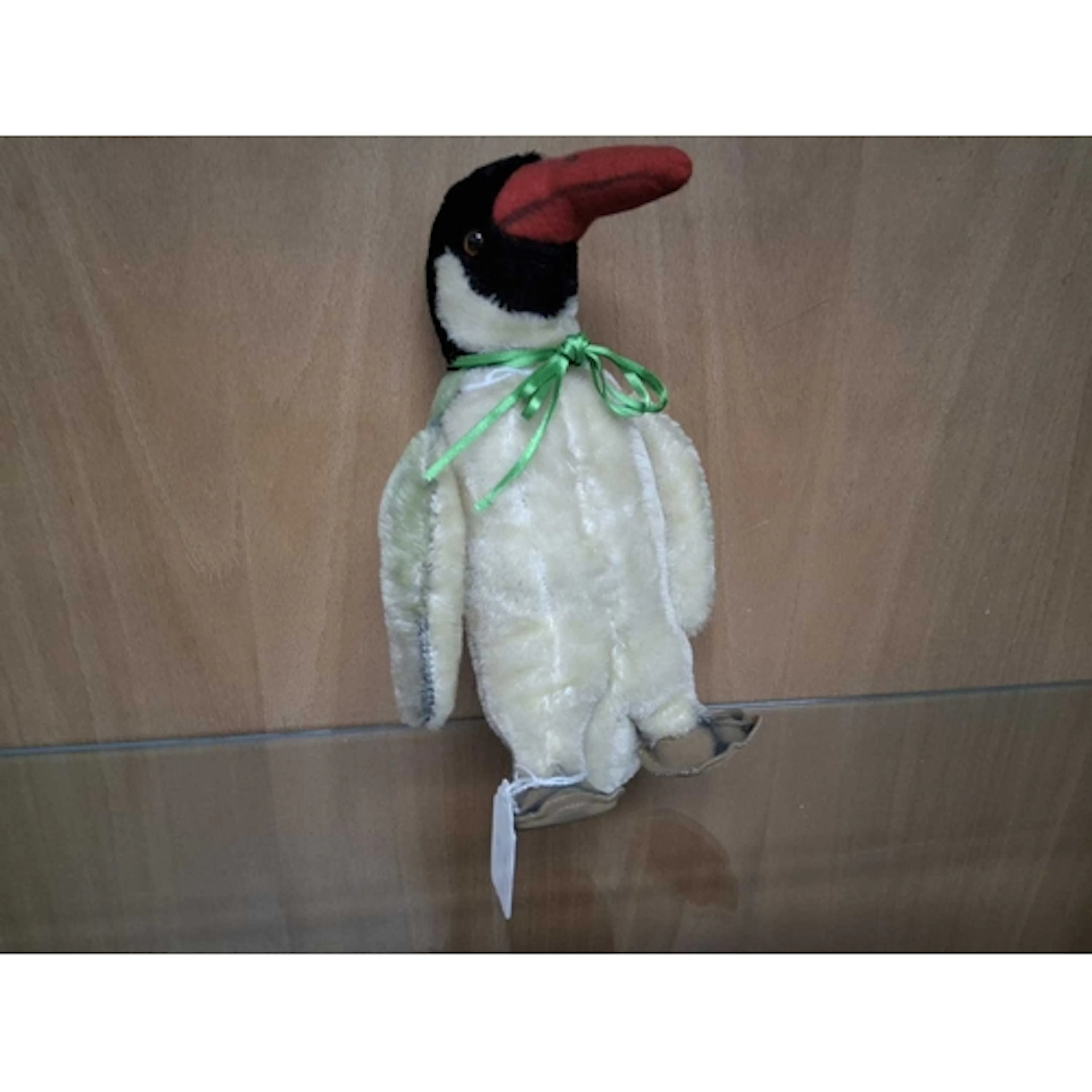 A VINTAGE STEIFF 'PEGGY' PENGUIN with a cream mohair body, a...