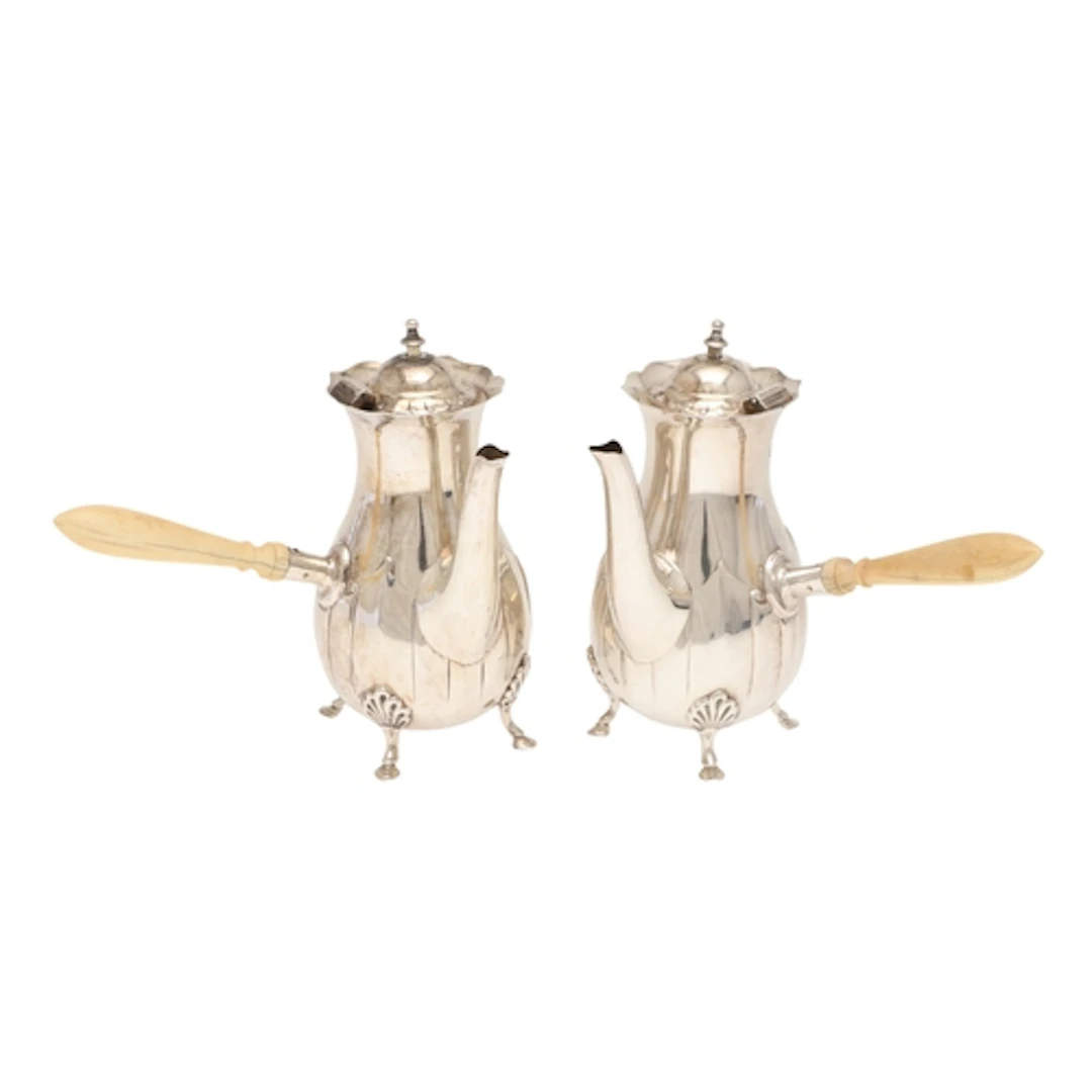 A PAIR OF EDWARDIAN SILVER COFFEE POTS. With a cut rim, the ...