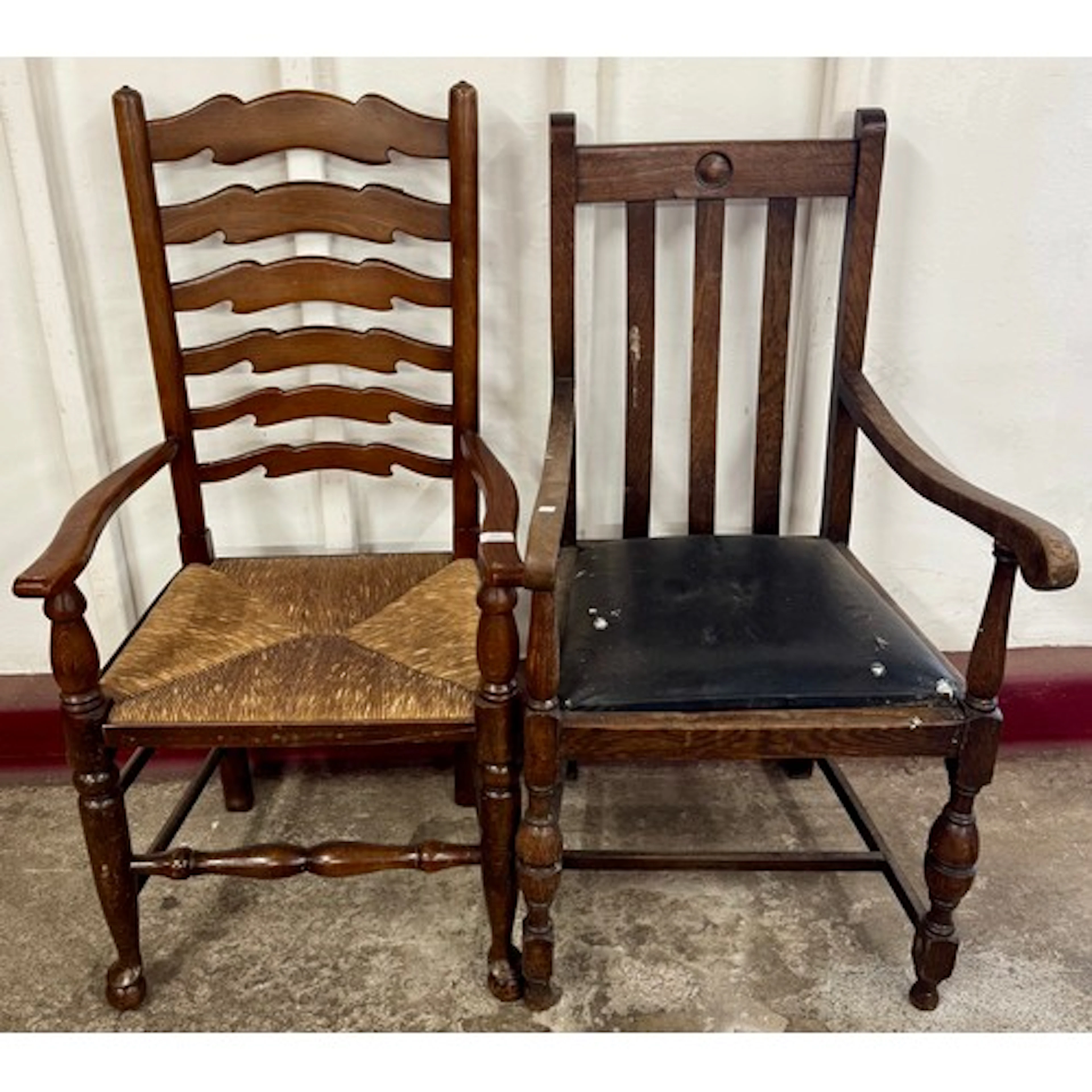 An Arts and Crafts oak elbow chair and an oak and rush seate...