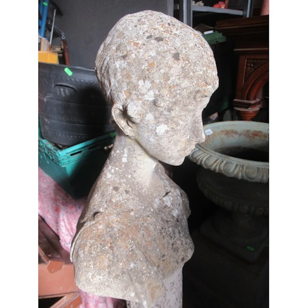 A garden stone bust of classical form raised on pedestal wit...