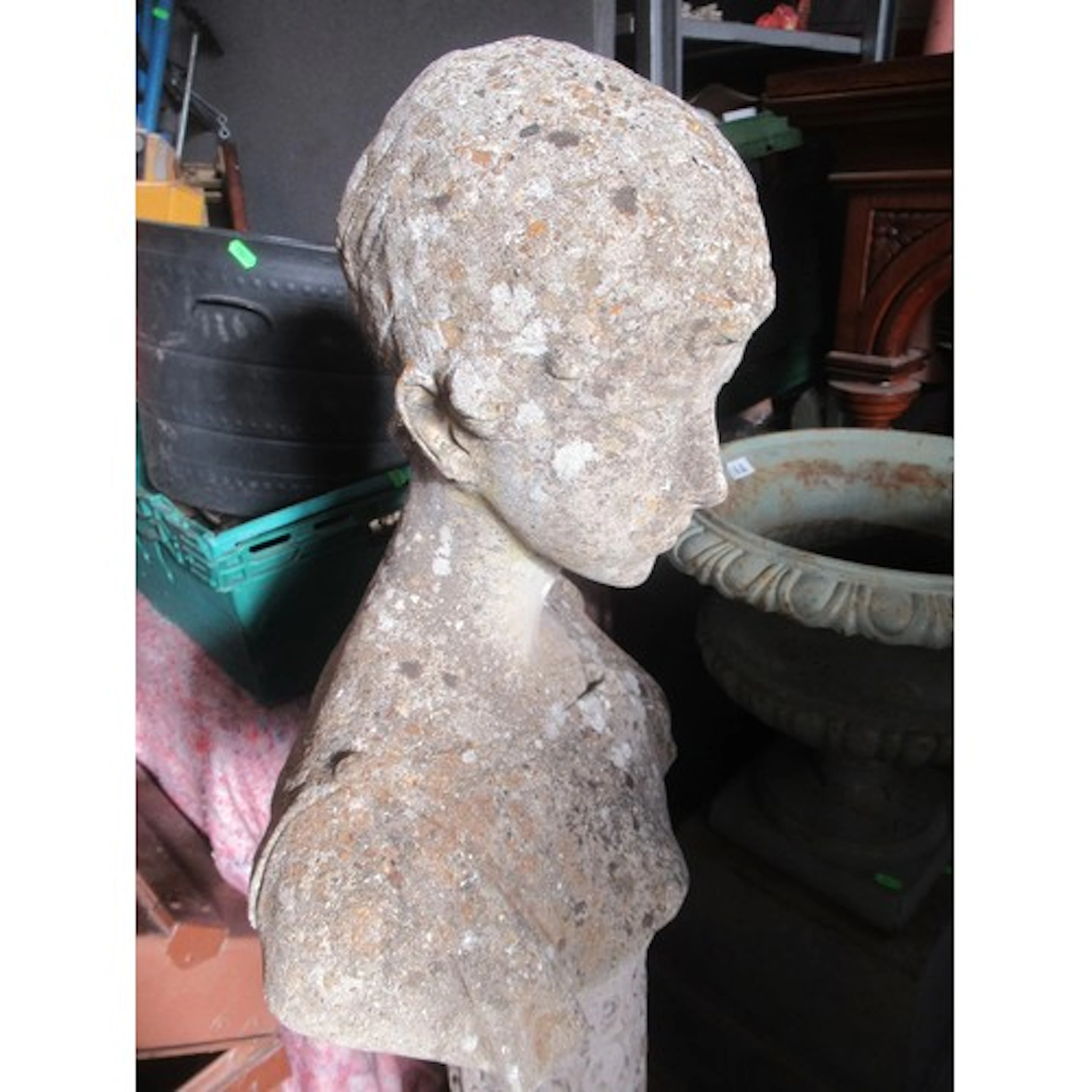 A garden stone bust of classical form raised on pedestal wit...