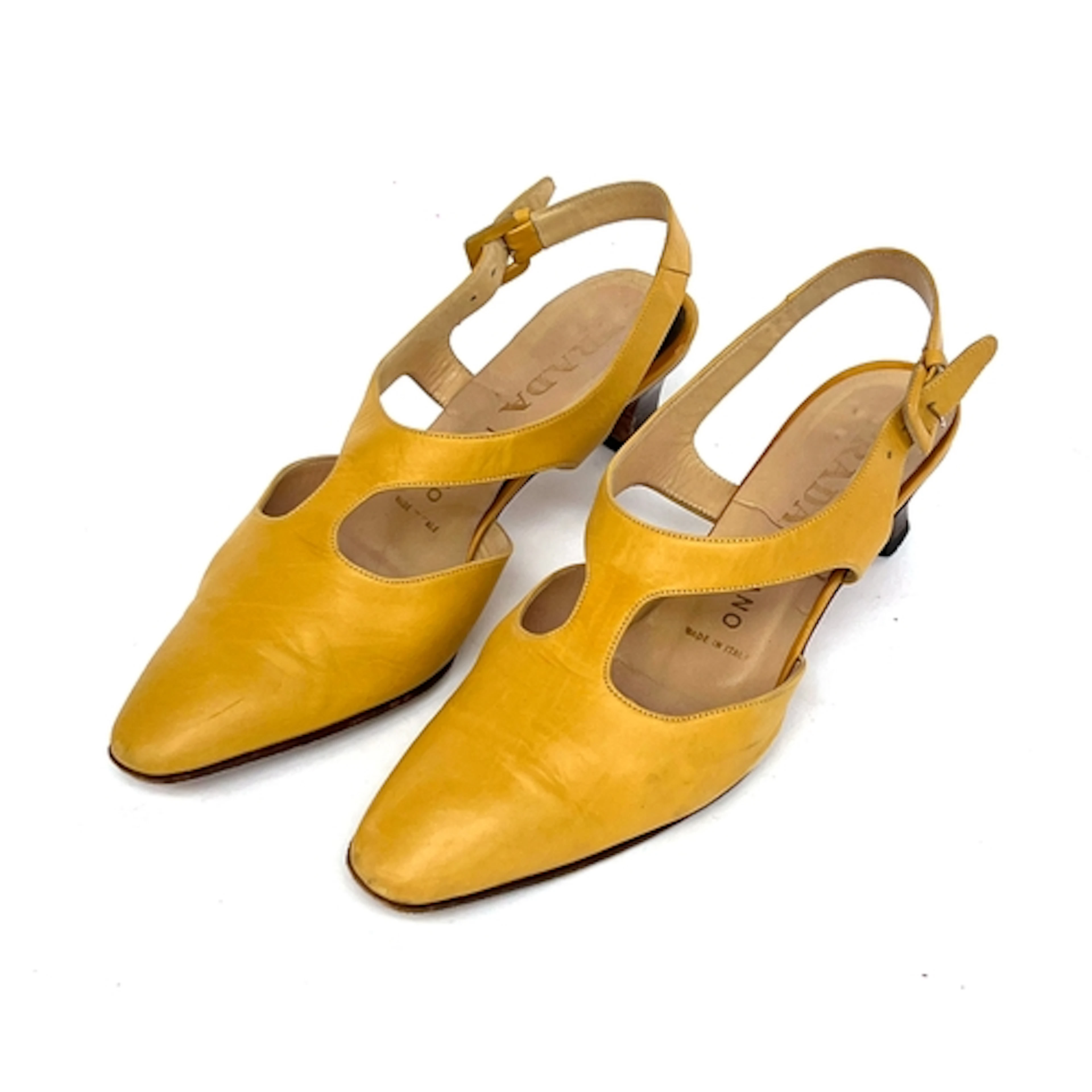 A pair of Prada mustard yellow leather heels with buckle fas...