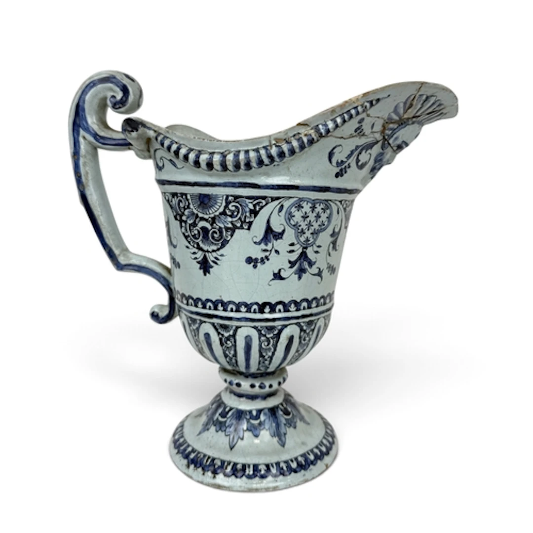 AN EARLY 19TH CENTURY DELFTWARE HELMET SHAPED JUG 24cm H...