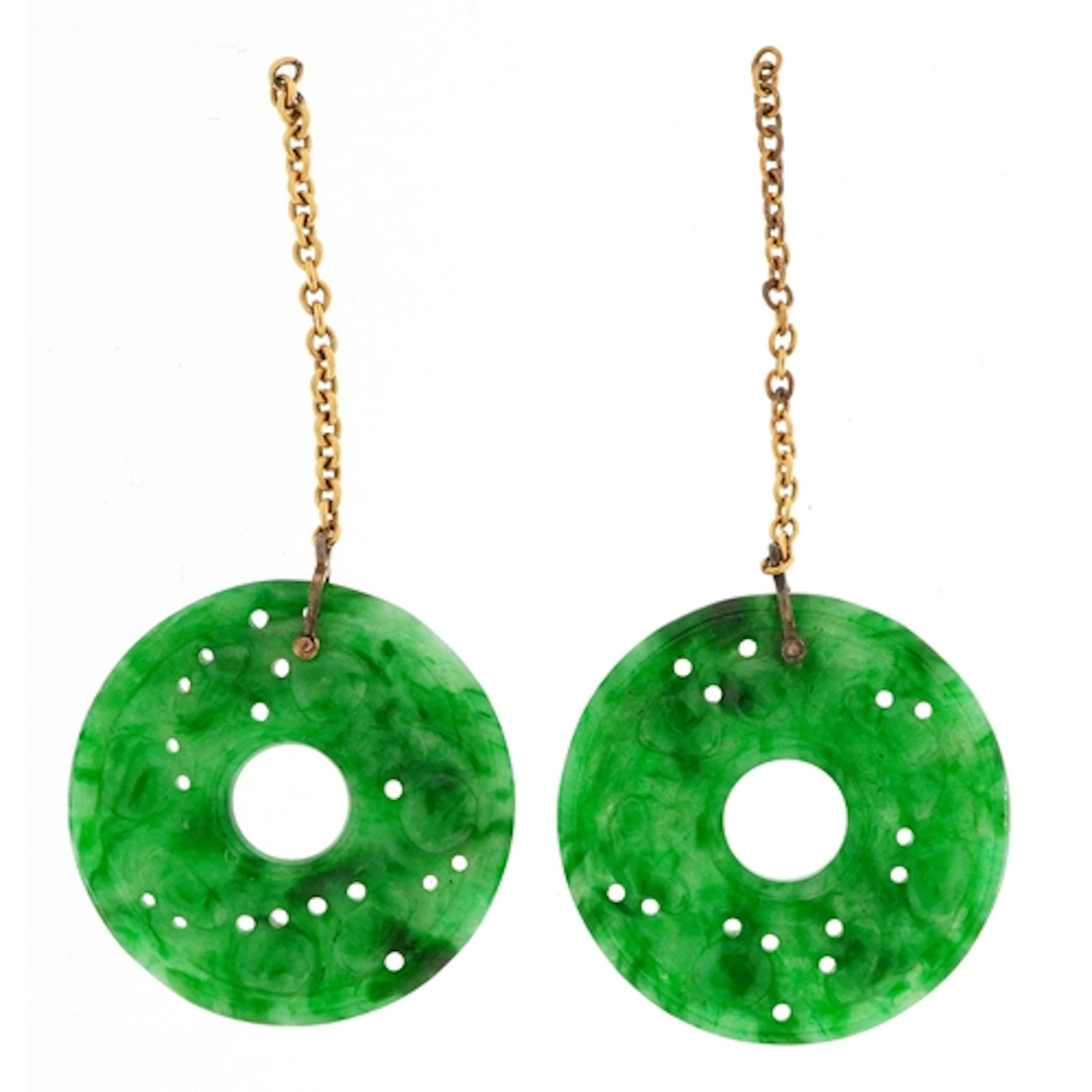 Pair of Chinese green stone discs carved with flowers, tests...