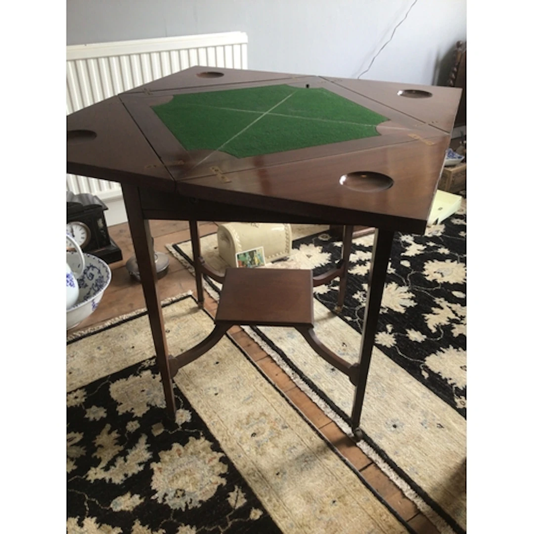 An Edwardian mahogany envelope card table with a quarterer t...