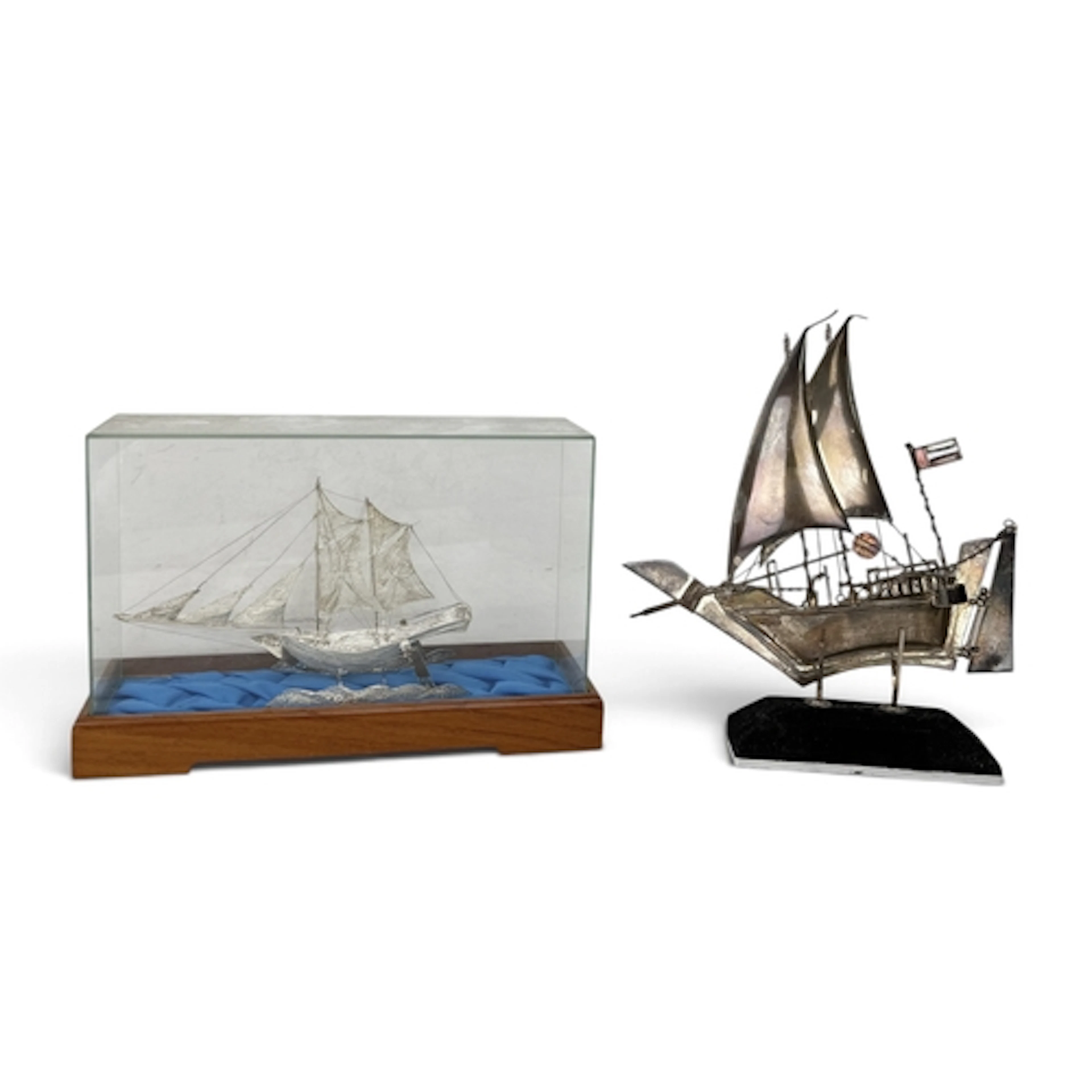 TWO SILVER SHIPS One marked 925. One in display case, the ot...