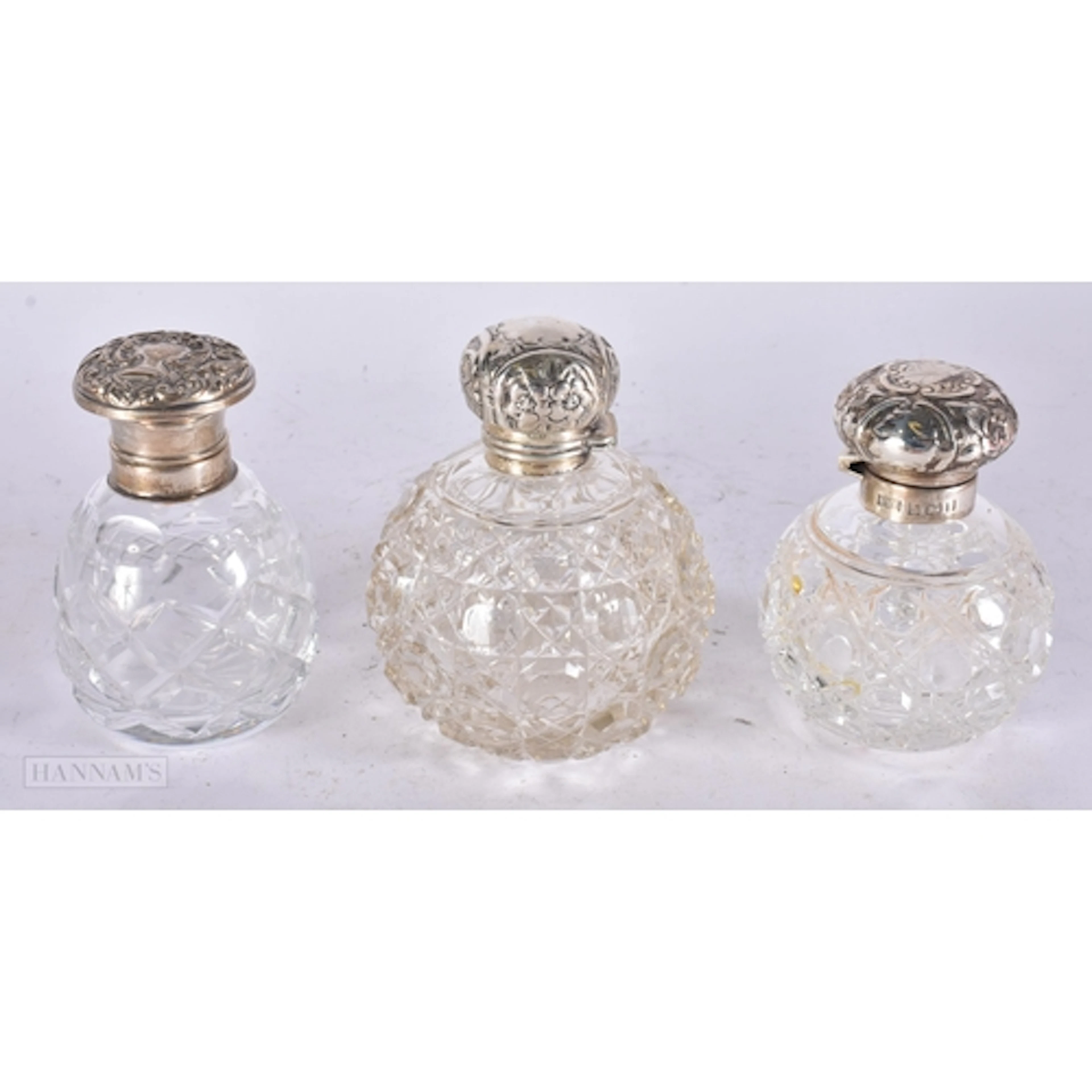 THREE ANTIQUE SILVER MOUNTED CUT GLASS SCENT BOTTLES. 12 cm ...