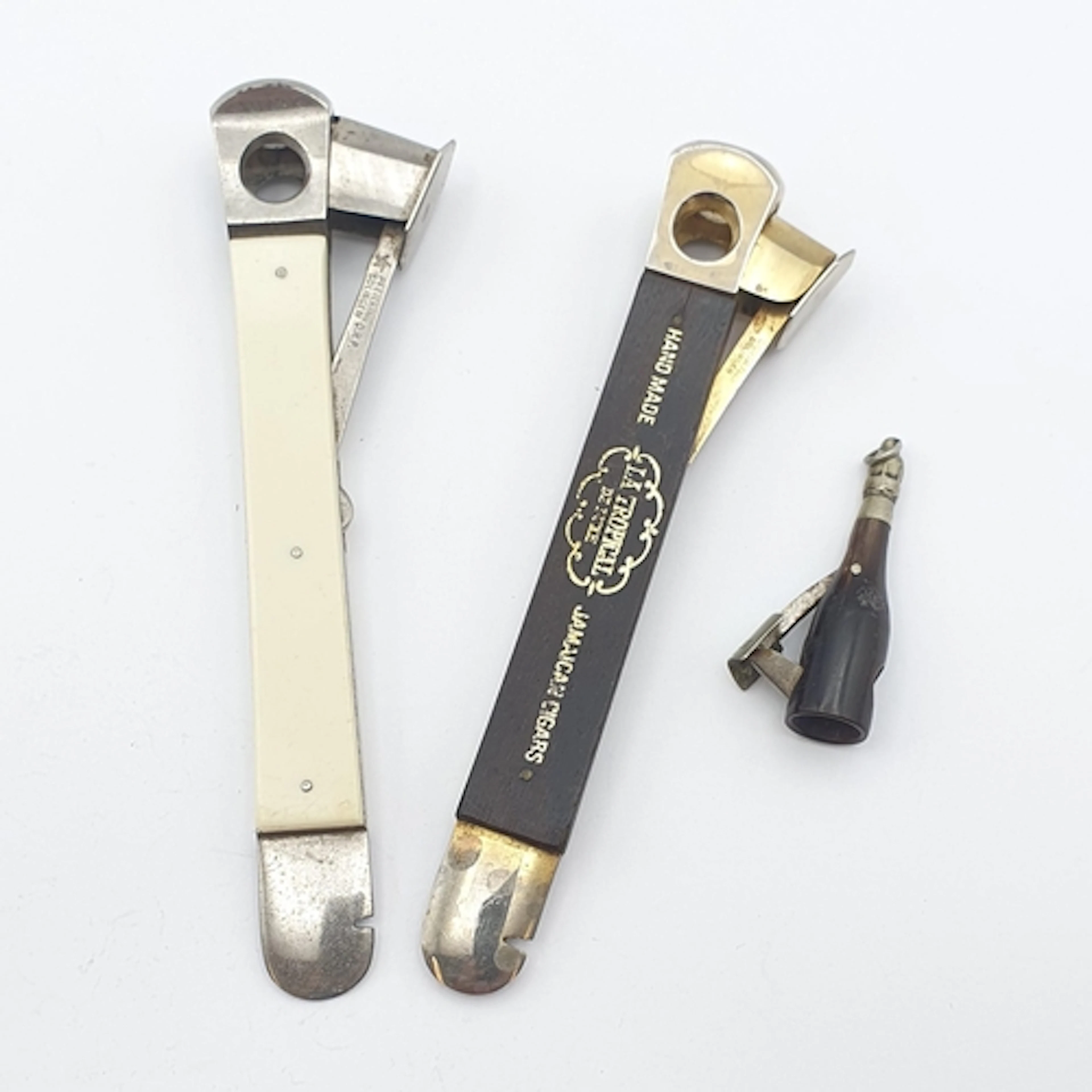 Two large Cigar Cutters and one small horn Cigar Cutter in t...