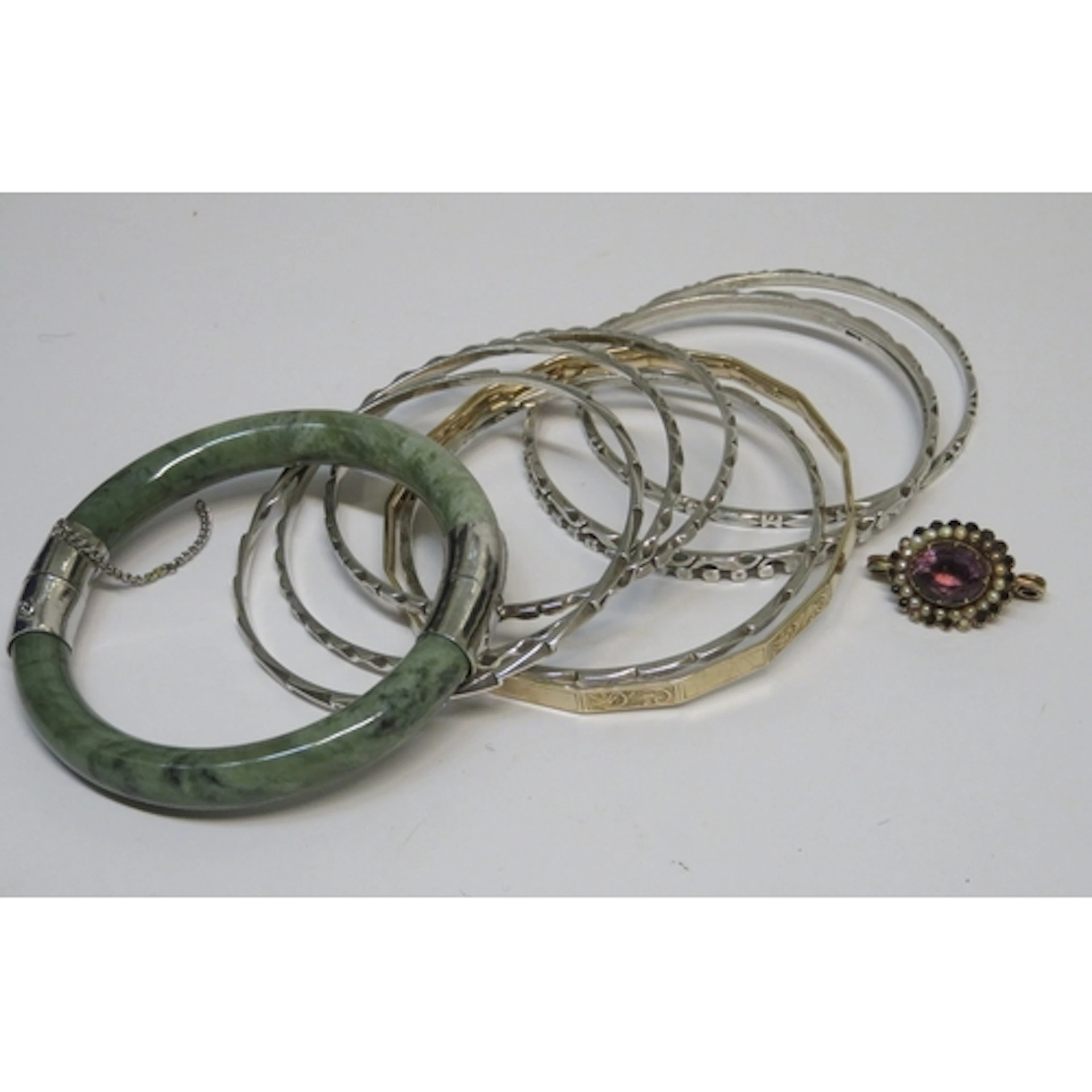 Seven Continental silver bangles together with a 9ct gold ba...