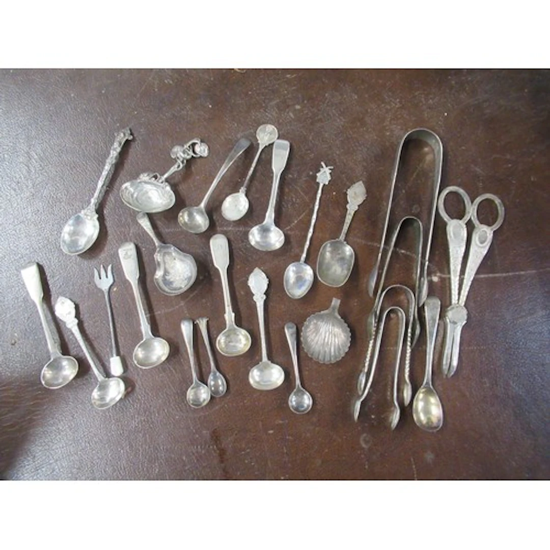 A collection of silver flatware, to include sugar tongs, gra...