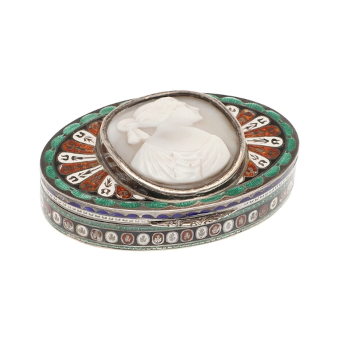 A SILVER AND ENAMEL SNUFF BOX. oval, enamelled in colours wi...