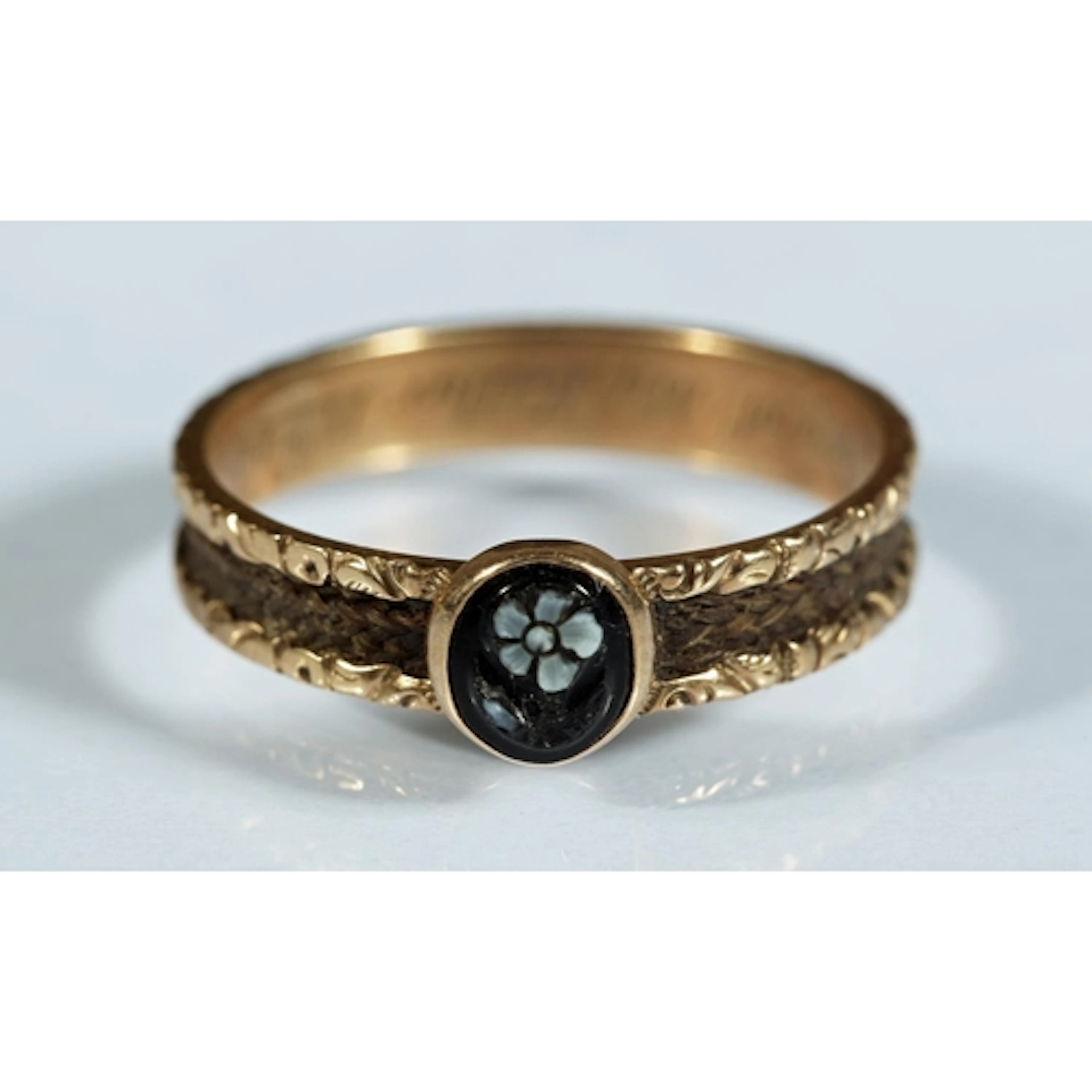 Victorian gold tone mourning ring set with carved black came...