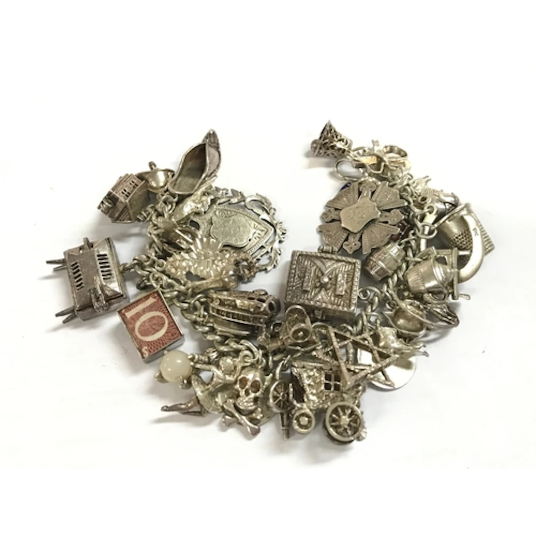 A heavy silver charm bracelet 134g total weight
