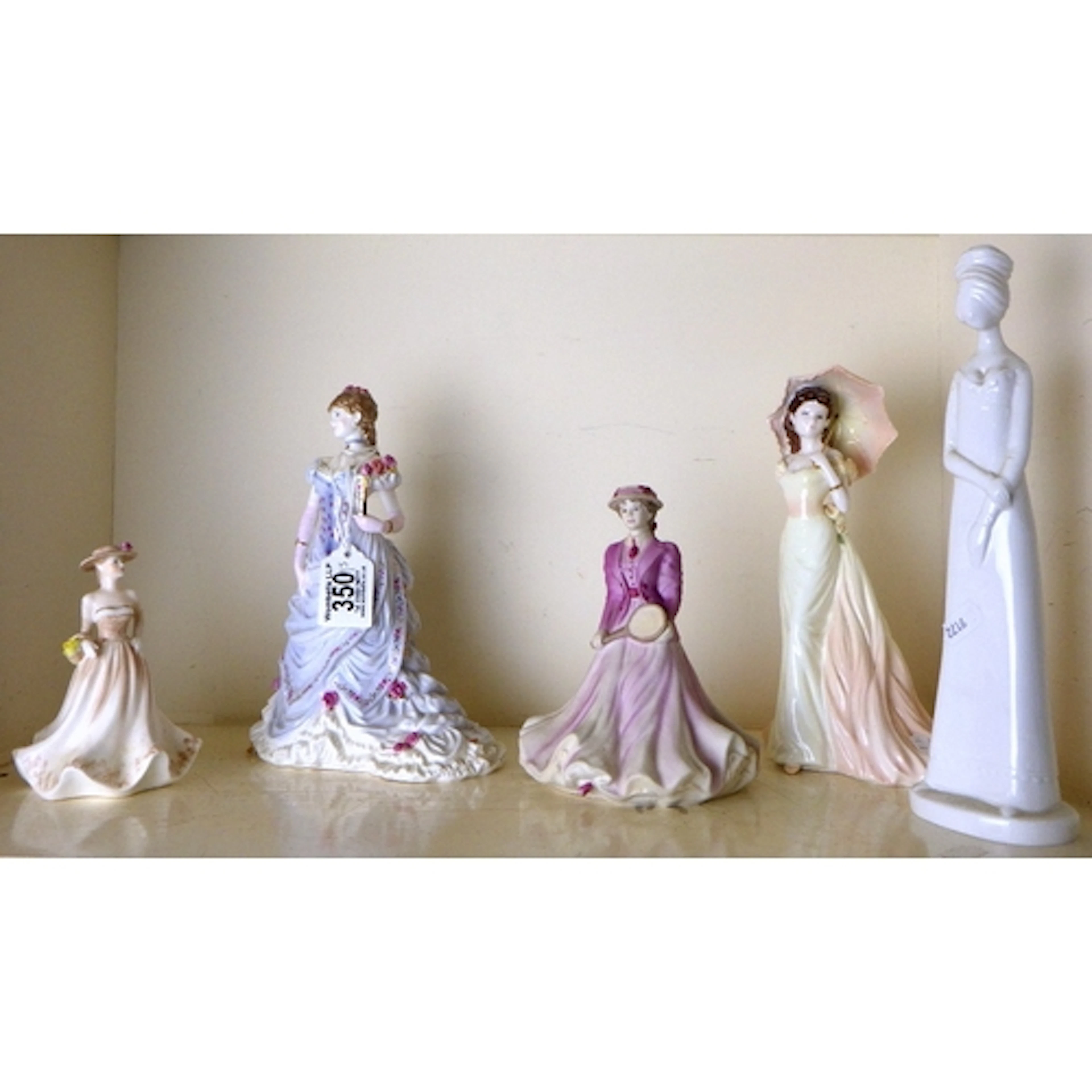 Three Coalport figures together with a Worcester and a Spode...
