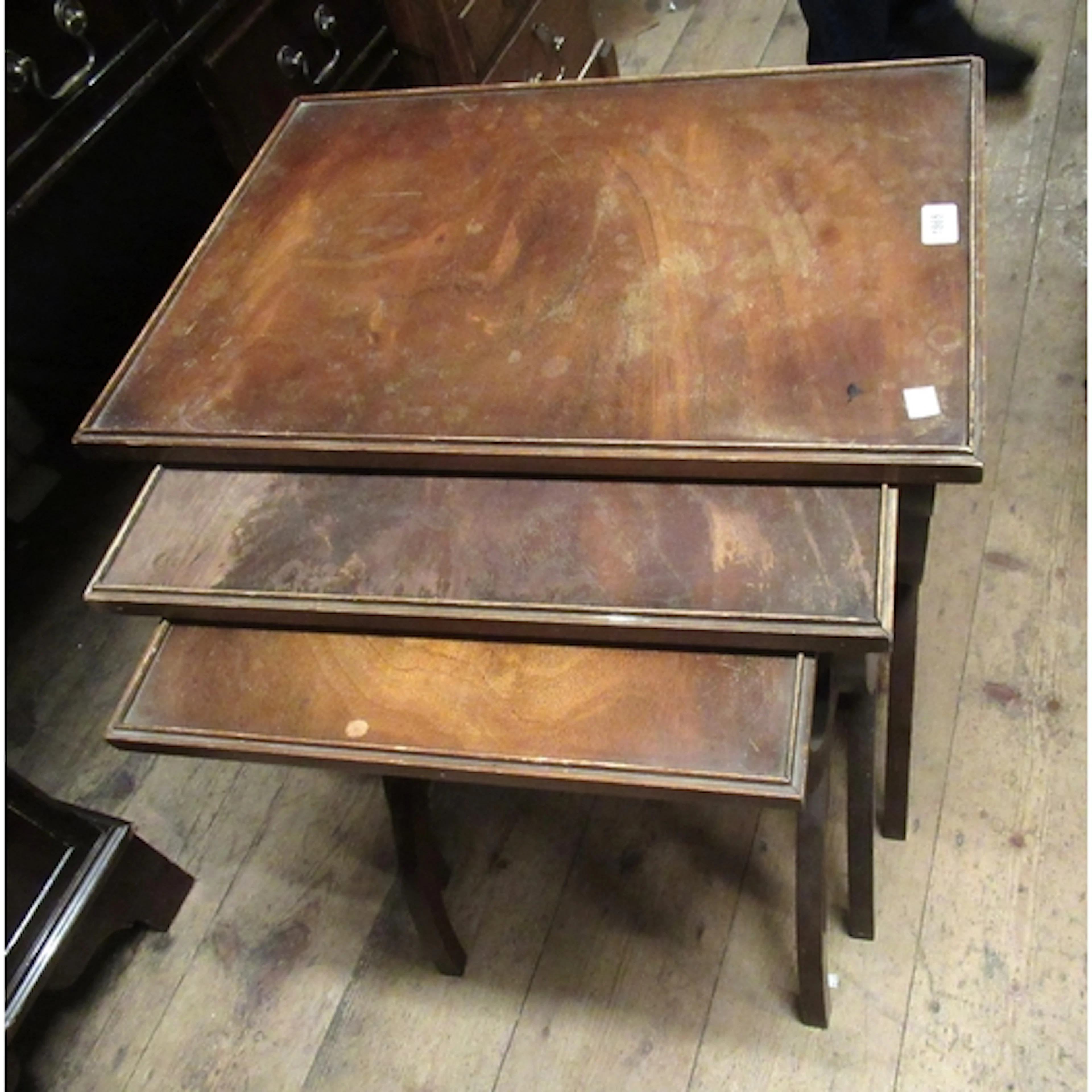 Nest of three rectangular walnut occasional tables on crosso...