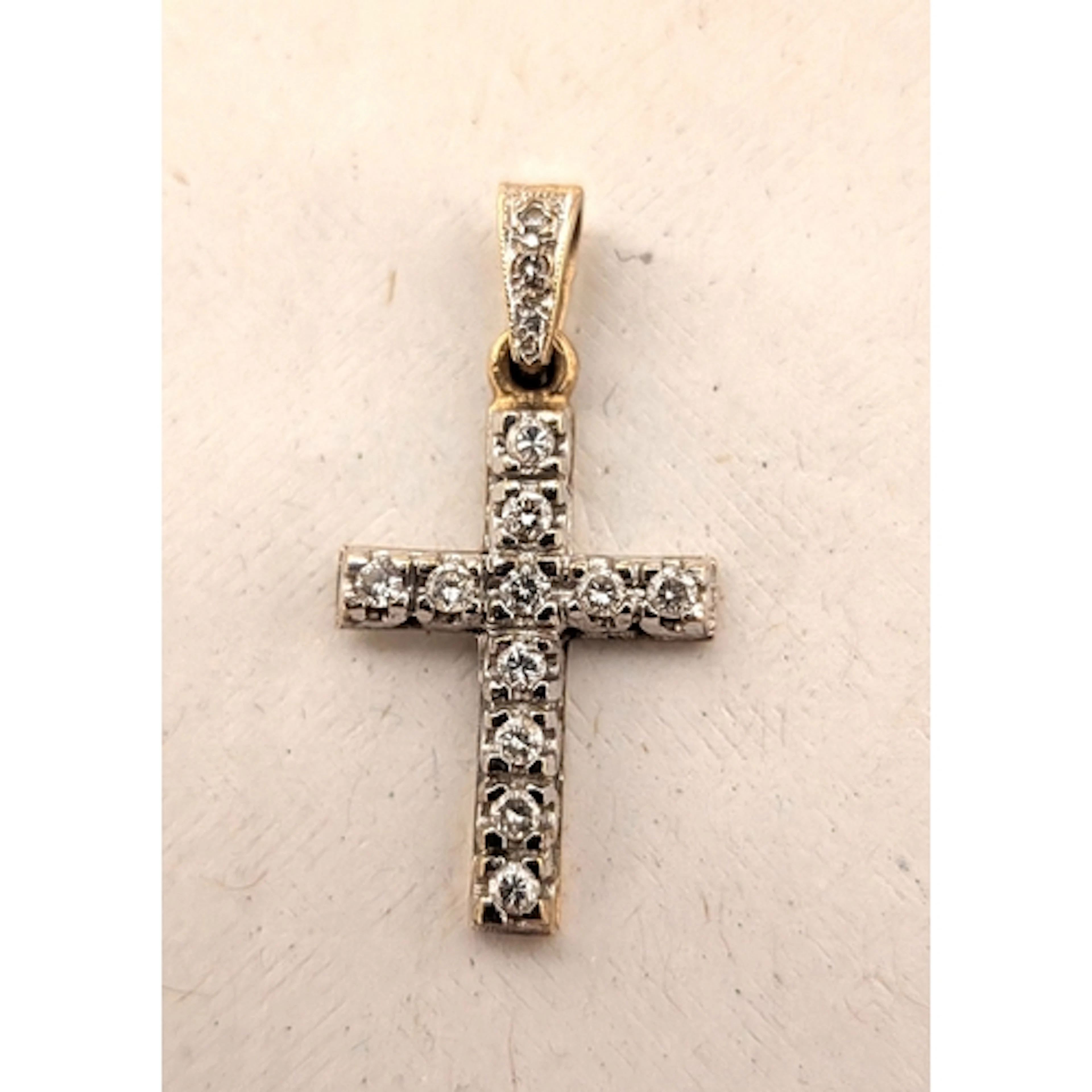 A diamond cross pendant, set with eleven brilliant cut diamo...