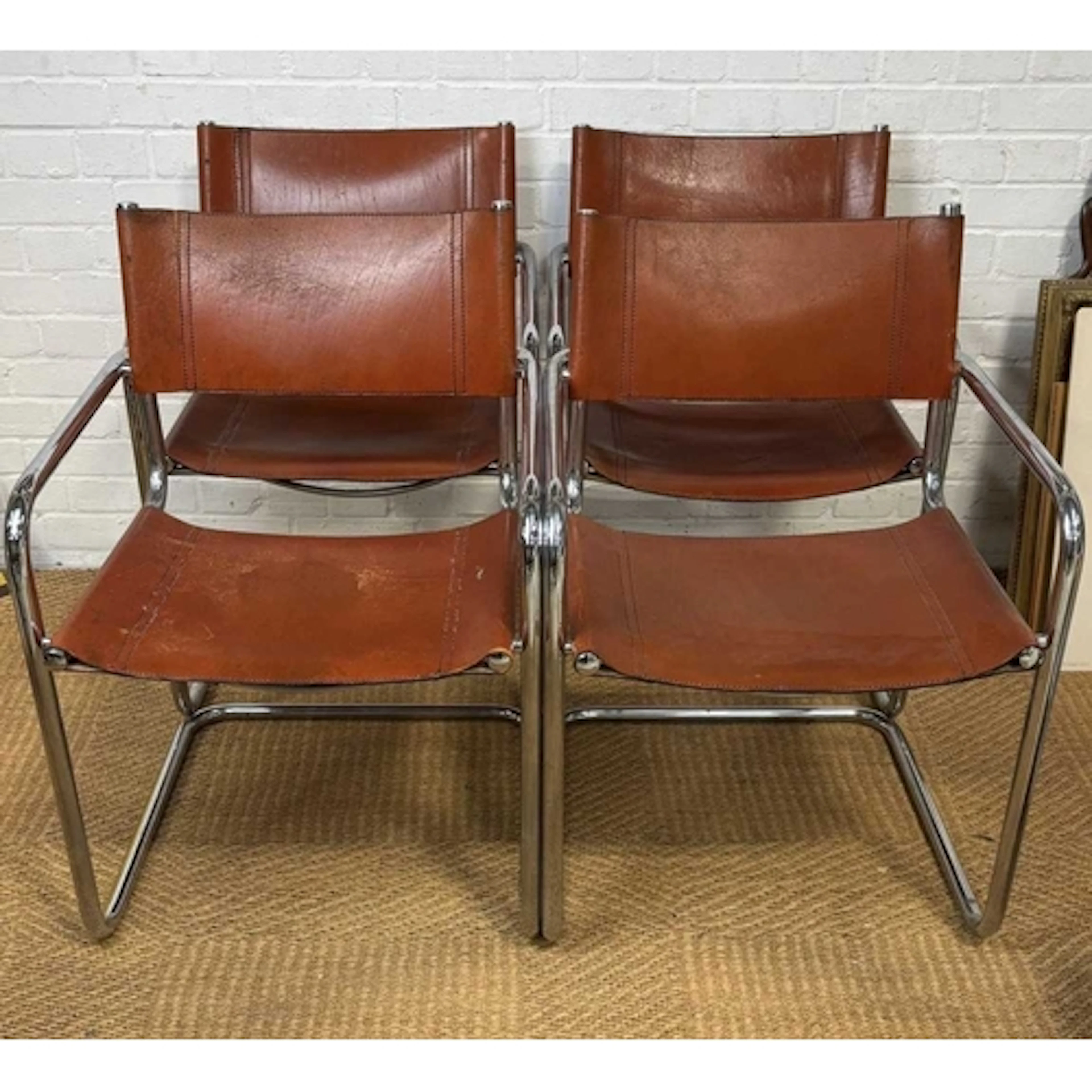 A SET OF FOUR CANTILEVER DINING CHAIRS, IN THE MANNER OF MAR...